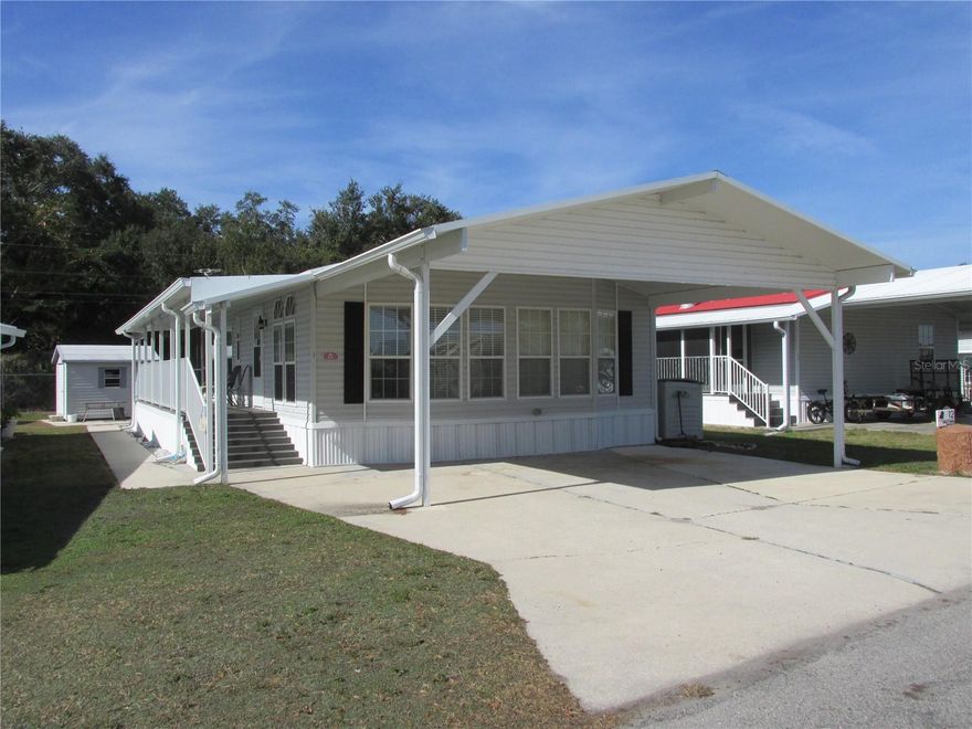 Located in the premier 55+ gated community of Saddlebag Lake Resort, this quality Jacobsen 2/2 manufactured home comes furnished. Upgrades include beautiful Pergo laminate flooring throughout the main living areas for ease of cleaning, and a whole house generator that runs on gas or propane and can power the entire house, for peace of mind in any kind of weather. The kitchen comes with a complete set of stainless steel appliances, including a glass top stove, double door refrigerator with ice maker and water dispenser, dishwasher and microwave. A dining table and chairs grace the dining room, where you will also find a built-in china cabinet. A BONUS ROOM was added at the rear of the home, perfect for a craft room or office. The exterior of the home has many extras, including a two-car carport, a full-length covered walkway with composite decking and a relaxing screened porch at the back. The low HOA includes your water, sewer and garbage pick-up, plus use of all the amenities, such as a clubhouse where you can participate in planned activities, a crystal clear community pool, screen enclosed hot tub, professional grade covered shuffleboard courts, tennis and pickle ball courts, and horse shoe pits, not to mention a rec room where you can play a friendly game of pool, use the fitness equipment or unwind in the sauna. Go boating and fishing in Saddlebag Lake, bask in the sun on the beach, or reserve the beach house for private parties. The resort is pet friendly, and there is a dog park just across from the driving range near the back of the community. Other perks in the resort include a post office and library. What are you waiting for? Call now for your private tour before this beauty is gone!