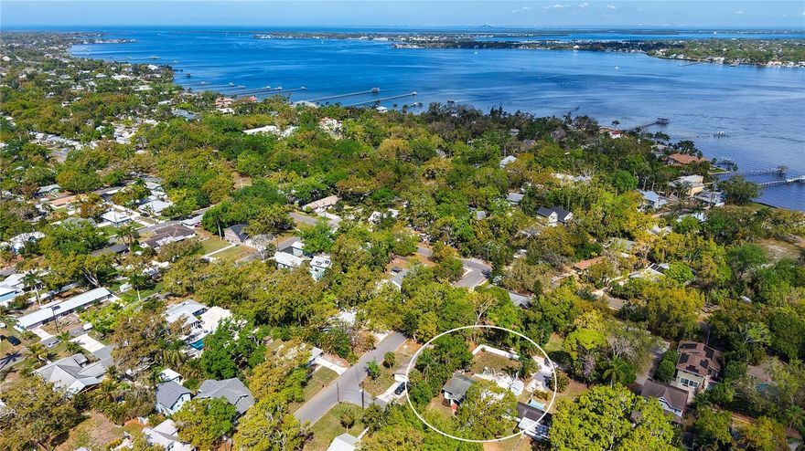 Welcome to this adorable 1930’s River District cottage just dripping in vintage charm! This one is truly special, from the rocking chair front porch with brick steps and original door hardware, to the original wood flooring in the craftsman living areas.  The working brick fireplace provides warmth and a cozy vibe, while the built ins offer storage and architectural interest. Natural light floods into the living spaces through the original casement deep-set windows.  The dining area is just off the kitchen and features large windows with built-in storage and easy access to the kitchen. There are two spacious bedrooms with original hardwood floors and a beautiful bath with checkerboard tile and an original claw-foot tub!  The kitchen is open and bright, with plentiful storage and windows looking out over the fully fenced backyard!  There is a bonus bath just off the kitchen with a stand-up tiled shower for convenience for guests or family. For additional convenience there is an interior laundry room just off the kitchen, leading out to the lush backyard that is spacious and open, with a vinyl fence that opens wide for cars, boats, or other toys.  The location is highly desirable, so close to downtown and the Manatee River, and just a short ride out to the beaches on Anna Maria Island and the best part is it isn't in an HOA.  Schedule your showing today!
