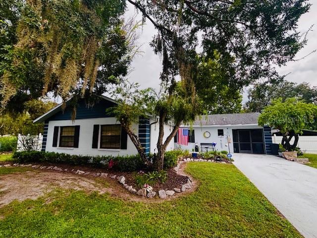 NO HOA !!! NO CDD !!! This Concrete Block 3 Bedroom, 2 Bath, 1 Car Garage Home Has No Deed Restrictions. Lovingly Maintained and Ready For A New Family. NO CARPETING !! All New Laminate Flooring and Ceramic Tile... The Eat In Kitchen has Solid Wood Cabinets and Corian Countertops. Huge Living Room Has Soaring Ceilings and a Bonus Area W/ Sliders that Lead Out to the Amazing Screened in Back Patio. SPLIT FLOOR PLAN !!! The Spacious Master Bedroom Has a Large Walk in Closet and En Suite Bathroom W/ Separate Water Closet, and A Fantastic Walk in Shower. The Other 2 Bedrooms Share a Full Bathroom. The Fenced Yard and Rear Carport Offering Privacy and Parking For Your Boat and Toys. 2 Storage Sheds For Work Space and Storage. Located Near Restaurants, Shopping, and a 4 minute Drive to the Hospital. 1 hour to Disney, Beaches, Major Sports Complexes and TIA.