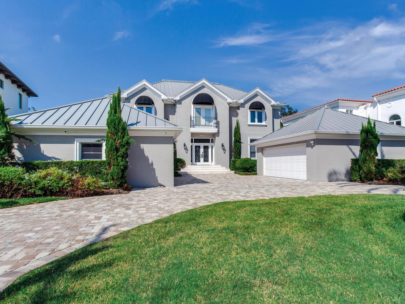 **This home is available for Sale and Lease.**This South Tampa home is on a high lot and suffered no water intrusion or any damage from the storms. House is on a block of mostly newer construction homes providing for a consistent ambiance for this waterfront neighborhood. It has a total light and airy contemporary feel with some traditional features within the beautiful hardwood floors, high ceilings and some special molding. The entrance has striking, beveled glass doors and stunning cabinet work on each side, flanking the formal living and dining room. Stepping through the front door, one will immediately notice the water view. While exploring this fabulous floorplan, notice the living and dining room have rich, inlayed wood floors that provide warmth and sophistication. On the first level, there is a generous den that is accompanied by a full bathroom which can easily be used as an additional bedroom, if needed. The expansive gourmet kitchen opens to the family room and the water views from these areas is spectacular. There are so many beautiful white cabinets in the kitchen and butler’s pantry that keeping the necessities will never be a problem. As well, the area leading to the family room has a bar with even more cabinetry. There is certainly no worry about storage in this home! The second floor is so cool…the primary bedroom is adjacent and connects to a second family room (or private living room), depending on which the owners want to use as a master, and the large primary bath are across the west side of the house with gorgeous arched windows and French doors opening to the balcony and overlooking the waterfront. This retreat would be hard to leave! There are two other bedrooms with fabulous baths and second hall seating areas and a third level bonus room. The guest house has its own kitchen and bath and faces the pool and gracious back yard. The dock is perfect with a slip type opening for the boat which includes a lift for out of water storage plus there is room for a table and chairs for outdoor dining. Another great feature of this waterfront haven is the outdoor covered dining on the home terrace providing the perfect setting for a sunset meal or entertaining. The house has a fabulous pavered circular driveway and has two, two-car garages housing up to four cars and includes even more storage space. The owners made many thoughtful upgrades since it was last purchased, and this home is an incredible value. This home's South Tampa location is conveniently located to A-rated schools, dining, shopping, entertainment venues, International Plaza, Raymond James Stadium, I-275, Tampa International Airport, Downtown Tampa, the Channelside District, bay bridges to the beaches and I-4 to Disney World.