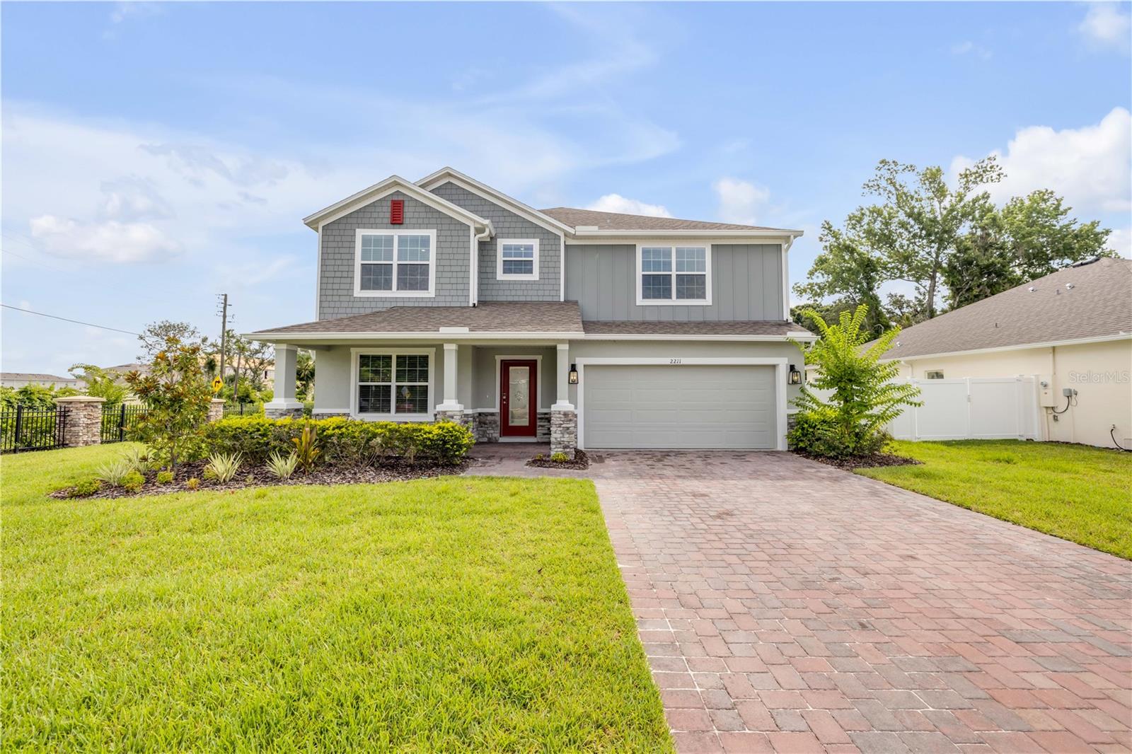 One or more photo(s) has been virtually staged. Never-lived-in former model home on a premium corner lot in Elegant Manor Estates with unmatched upgrades and curb appeal! This 4-bedroom, 2.5-bath home offers nearly 2,800 sq ft of elevated living space, including two lofts and a main-level flex room with wardrobe—ideal as a 5th bedroom or office. Features include soaring ceilings, abundant natural light, custom tile flooring, smart stainless appliances, upgraded cabinetry and quartz counters throughout the kitchen, baths, and laundry, designer lighting, accent walls, custom millwork, and custom window treatments. The open layout flows into a spacious kitchen with an oversized island and breakfast bar—perfect for entertaining! Upstairs, enjoy plush carpeting and a luxurious primary suite with tray ceilings and spa-like bath. Outside, you’ll find upgraded landscaping, a 3-car garage, smart security system, covered front porch, extended rear patio, and a fully fenced yard with a one-of-a-kind irrigated living wall. Move-in ready—just minutes from beaches and shopping!