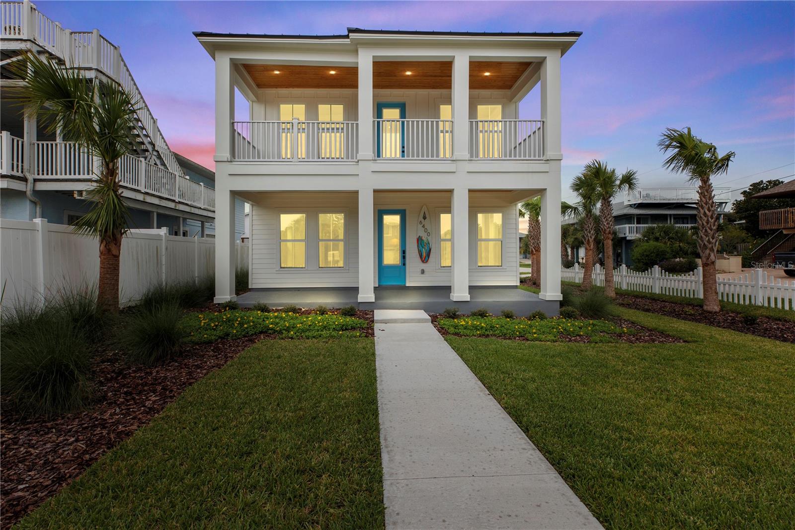Construction recently finished so its finally fully ready for you to see! FULLY FURNISHED and sandwiched right between the quiet beach and the intercoastal waters, this brand NEW, two story block construction with a balcony ocean view home is perfectly located in the New Smyrna/ Bethune Beach area. This professionally designed showcase home's exterior is solid, built for safety, and features a large entry porch, upstairs balcony with a view of the ocean, new landscaping, picket fencing, cement board vertical and horizontal siding, metal roofing, double paned- impact resistant vinyl windows, premium coastal A/C system, an outdoor shower and sliding glass doors. The floorplan and living space have been luxuriously designed with TWO master suites, TWO living rooms, TWO laundry areas (one upstairs, one downstairs) PLUS a large "bunk" room that can house multiple beds. Interior upgrades and features include professionally decorated lighting, mirrors, tile and flooring selections, stacked microwave/oven, stainless steel appliances, floating shelves, quartz countertops, cooktop w/hood, wood cabinetry, window treatments, large closets, shiplap custom wood work on walls, 8ft doors downstairs and additional storage. This home is only a block from (and is equidistant ) to ocean access and intercoastal waters, close to JB's fish camp and local shopping!