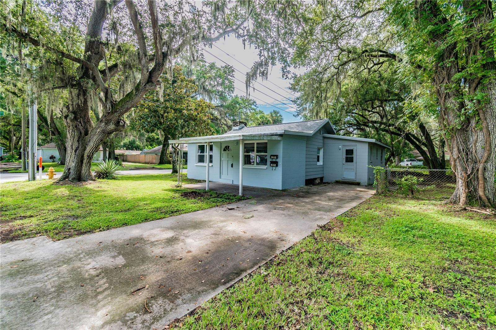 This is a fantastic investment opportunity! This duplex is situated in downtown New Port Richey, at the intersection of Kenwood Avenue and Washington Street. The front unit is a spacious studio that features a kitchen, fireplace, remodeled bathroom, and a large enclosed front porch, along with its own private driveway. The back unit, accessible via a private driveway off Washington Street, also offers a generous studio layout with a living area, kitchen, and a remodeled bathroom. The property boasts a sizable yard with ample space for RV or boat parking. It is zoned for a triplex and has three addresses, although it currently contains only two units. Additionally, there is a common area laundry room located between the two units. The roof was replaced in 2018, and the exterior was freshly painted in 2024, with both bathrooms remodeled in the same year. Downtown New Port Richey is rich in culture and heritage, featuring a community boat launch and a charming riverfront atmosphere. Founded in 1924, this area exudes timeless appeal and small-town hospitality, with historical landmarks such as the Hacienda Hotel, Richey Suncoast Theatre, museums, local restaurants, boutiques, bars, and breweries all just moments away.