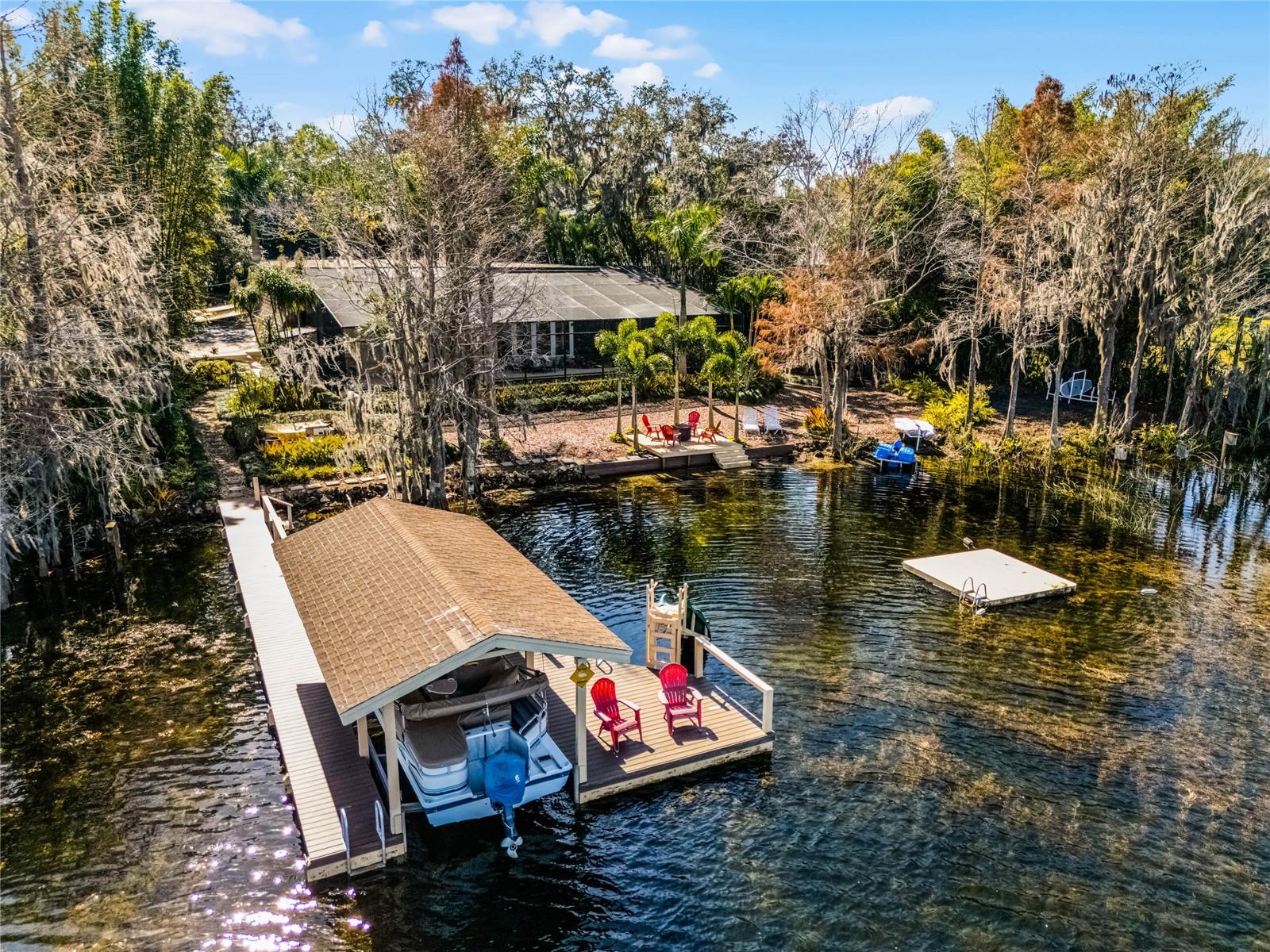 Exceptional lakefront opportunity on the BUTLER CHAIN of Lakes! Nestled on the pristine shores of Wauseon Bay, this rare lakefront property offers an unparalleled opportunity to create the ultimate luxury retreat on the coveted Butler Chain. Set on a pristine, oversized lot (~1.26 acres) in one of the area’s most sought-after locations, this FENCED property offers a rare opportunity to create your dream home. This solid BLOCK home boasts breathtaking WATER views, a grand, tree-lined driveway with private GATE, and a setting that exudes elegance and privacy. While the residence itself could use some updating, the setting is nothing short of spectacular offering a picturesque backdrop, mature landscaping, and a premier location that enhances both value and vision. Featuring a spacious layout with soaring ceilings and panoramic lake views, this home is ready to be transformed into a masterpiece. The prime waterfront location offers direct access to the Butler Chain known for renowned boating, fishing, and water sports, making it an ideal sanctuary for lake lovers. Whether you envision a modern showpiece or a timeless estate, this property presents the perfect canvas to bring your vision to life. The home features 6 bedrooms, 5.5 baths (4 en-suite baths), a 3-car garage, 14 X 60 SALTWATER and heated pool/spa with screen-enclosure, two fireplaces (natural gas), a dock for your watercraft along with a floating swim dock, and a sitting area by the water that’s perfect for a cozy night by the fire. Upstairs you’ll find the primary suite along with 3 other bedrooms and 3 en-suite baths. The PRIMARY suite faces the water and features a fireplace, dual sinks, a garden tub, separate shower, and two walk-in closets. The downstairs area includes two additional rooms, 1.5 baths, a formal dining area, living area, a sitting area with a wood burning fireplace overlooking the pool and lake, as well as a bar, which is perfect for entertaining your guests. The kitchen is spacious in size and includes STAINLESS appliances. UPDATES: 5 ton AC 2023, 3.5 ton AC 2016, PebbleTec pool finish 2015, upstairs gas fireplace 2016, tankless water heater 2016, septic field (front of home) 2016. The Butler Chain of Lakes is one of Central Florida’s most prestigious and sought-after freshwater lake systems, located in Windermere and Southwest Orlando. This chain consists of 13 interconnected lakes, known for their crystal-clear waters, sandy bottoms, and exceptional boating, fishing, and waterfront living. Enjoy a rare combination of luxury, recreation, and natural beauty, all while being just minutes from Disney, golf courses, upscale shopping, fine dining, and top-rated schools. Windermere is a GOLF CART friendly community where you’ll find a brewery, coffee shop, dining, a Farmer’s Market, tennis courts, parks, a boat ramp, and more. Opportunities like this are rare, don’t miss the chance to transform this hidden gem into a one-of-a-kind lakefront estate!