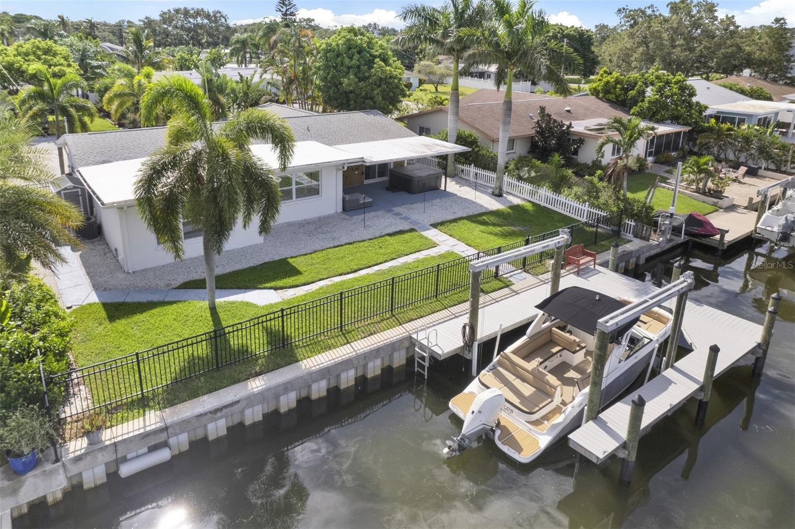 Under contract-accepting backup offers. Incredible opportunity to snag waterfront property in Dunedin at a heavily discounted price. If you’ve been searching for the best waterfront deal in Pinellas County—this is it. This beautifully updated 3-bedroom, 2-bath home is tucked away on a deep water canal just moments from open water. Enjoy Florida living and a boater's dream. Take your boat, jet ski or paddle board on a short ride through the canal, leading you to the Gulf of America. Whether you're into fishing, leisurely rides, or just enjoying the sun and water, this property truly embodies the Florida lifestyle. The backyard, with an outdoor kitchen, is made for entertaining, sunsets, or future pool days—plus, there’s a newer seawall, a composite dock, and a 13,000 lb. remote-controlled boat lift. Beautifully remodeled after some flooding in 2024, this property is being sold as-is at a steeply discounted price for a quick sale. You're just around the corner from the Pinellas Trail and a quick bike ride to downtown Dunedin—where you’ll find great dining, shopping, festivals, and nightlife. And if the beach is calling, Honeymoon Island and the Dunedin Causeway are just about a mile away. Schedule your showing today, this opportunity will not last long.