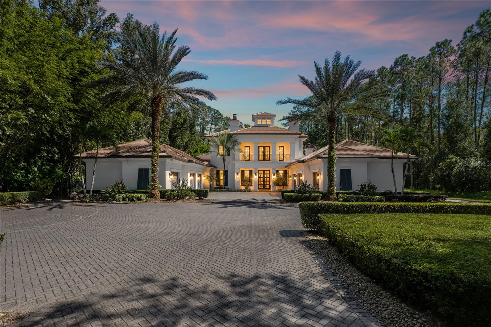 Private Lakefront Estate on Lake Pickett! Experience the ultimate in privacy and resort-style living with this one-of-a-kind gated lakefront 4.14-acre estate on the pristine, spring-fed waters of Lake Pickett. Set on beautifully landscaped grounds with bamboo privacy walls and a long private drive, this custom-built residence combines architectural excellence with exceptional craftsmanship. Built in 2016, this home features 5 spacious bedrooms with en-suite bathrooms and 5 half bathrooms. An entertainer's dream with gourmet chef's kitchen, wine cellar, game room with wet bar, lakeside cabana and media room. Over 2,000 SF of covered outdoor living with built-in heaters, outdoor kitchen, 5 fireplaces, custom saltwater pool/spa with edgeless design. Two-story dock with boat lift for boating enthusiasts. Featuring soaring ceilings, custom cabinetry, reclaimed wood accents, and a state-of-the-art Control4 smart home system with whole-house audio, lighting, and security. The chef’s kitchen is a culinary masterpiece with Thermador and Sub-Zero appliances, a Wolf gas range, double ovens, two dishwashers, and an oversized island perfect for hosting. Enjoy movie nights in the fiber-optic home theater, unwind by one of five fireplaces, or take in the panoramic lake views from the expansive lanai. Outdoors, a resort-inspired pool, modeled after The Cove at Atlantis, features a perimeter overflow design, sunken lounging areas, and fountains. Entertain lakeside at the outdoor kitchen and bar with a translucent granite countertop that glows at night. The two-story Ipe Wood dock offers a boat lift, upper entertainment deck, and stunning sunset views over one of Florida’s cleanest private lakes. Additional highlights include a 6+ car garage with a climate-controlled workshop, a detached garage that could be converted to a guest suite with a breezeway to the lakeside cabana. This home also has a 45KW generator and a hidden room in case of emergencies. With unmatched attention to detail, this property delivers a rare combination of sophistication, functionality, and Florida lakefront luxury.