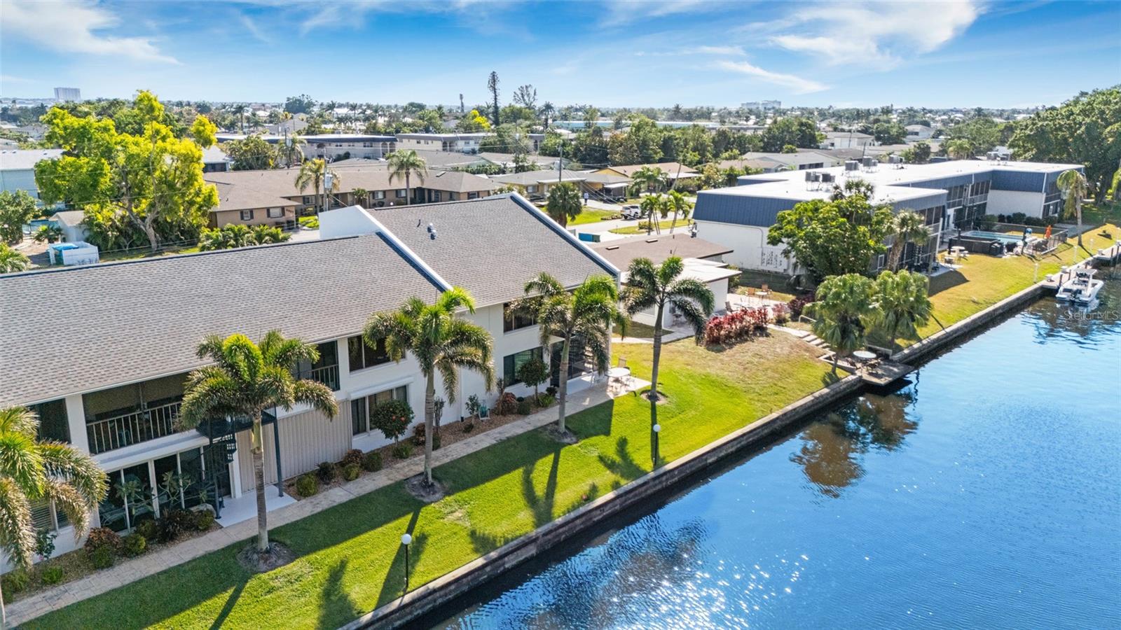 Your Waterfront Oasis Awaits! Step into this chic and tastefully updated 3-bedroom, 3-bathroom townhouse boasting 1,764 sq. ft. of elegantly updated living space. Perfectly suited as a lucrative investment or your dream forever home, this waterfront gem offers an unmatched lifestyle of luxury and leisure. Embrace Florida living at its finest with Gulf access right from your backyard—reach open waters in just five minutes! Imagine effortlessly setting sail or simply relaxing on your newly upgraded dock, complete with fresh decking ideal for boaters or sunset enthusiasts. Peace of mind meets contemporary style with recent enhancements including a brand-new roof, downspouts, and soffits, fresh exterior paint, and upcoming carports. Dual master suites—one conveniently located on each floor—provide exceptional privacy and flexibility, ideal for family, guests, or hosting. The kitchen is a culinary dream, fully remodeled with sleek finishes and modern functionality. Year-round comfort is guaranteed by the efficient 2016 AC unit. Unwind poolside at the heated community pool, or savor the captivating western sunsets from your private balcony, illuminating serene water views each evening. Ideally positioned near upscale dining, exciting entertainment, and premier shopping venues, you’ll appreciate the perfect balance of convenience and tranquility. This turnkey-ready home, with negotiable furnishings, invites you to dive right into your vibrant waterfront lifestyle. Priced to move quickly, this unique opportunity won’t last long. Schedule your private showing today and let your waterfront dreams come true!