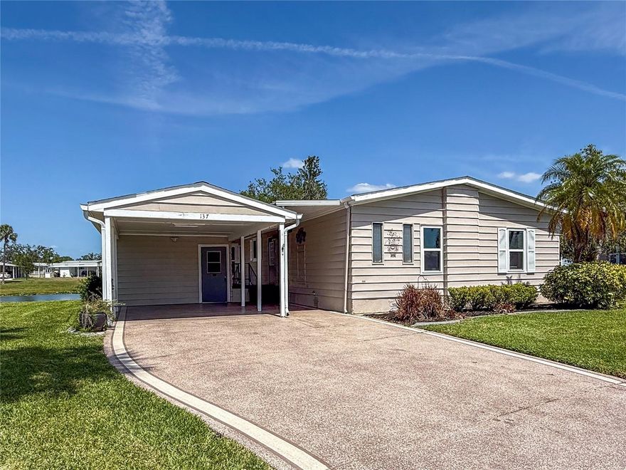 Enjoy the Florida Lifestyle in this beautiful updated, land owned, 2 bd/2ba home with amazing lake views. Home features a spectacular Florida room with new windows and AC.  Upgraded flooring and carpet thoughout with new style double pane windows.  Large living room and dining area with lake views.  A fully appointed kitchen with stainless appliances.  Primary bedroom has ample room for a king sized bed and has a walk-in closet. Large air conditioned workshop with extra-wide driveway and a hidden patio for grilling or sunbathing. ...this is a must-see home! The 55+ Ridgewood Meadows community features a beautiful clubhouse, pool, spa, tennis courts, pickle ball courts, shuffleboard and an outdoor fitness area. This community is also golf cart and small pet friendly. Ridgewood location has close access to I-75, many restaurants, the Ellenton Outlet Mall, the Manatee County Library. Ridgewood Oaks provides 24 hour gated security and lots of planned community activities to enjoy.   All room sizes are approximate. All information is deemed reliable but should be verified by buyers and/or buyer's agent.