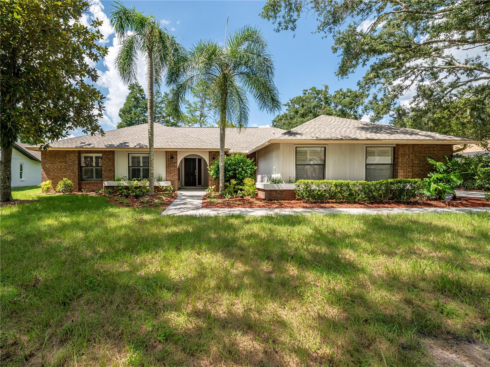 Welcome to your Dream Home in the Prestigious Tampa Palms Community ! Located in the Highly Sought-After Cambridge II Village, this Beautifully Updated 4 Bedroom, 2 Bath Residence offers Quality Upgrades, Modern Features, and the Best of Florida Living. In 2025 the Roof was Replaced to Add Peace of Mind. Step Inside to find Elegant Travertine Flooring throughout the Main Living areas and Luxury Vinyl Tile Planks in all Bedrooms and the Spacious Great Room, with NO Carpet Anywhere. This Sizeable Split Floor Plan offers Privacy and Flexibility, with the Primary Suite and an Adjacent Bedroom (Perfect for a Nursery, Office, or Library) on One Side, and 2 Additional Oversized Bedrooms with a Shared Updated Bath on the Opposite Wing. The Newly Renovated Primary Bath is ADA Compliant, Complete with a Wheelchair Accessible Toilet, a Freestanding Soaking Tub, and a Luxurious Zero-entry Shower with 2 Handheld Devices and a Free-Falling Rainfall Fixture. The Heart of the Home is the Stunning Great Room, Featuring Cathedral Ceilings with Decorative Wooden Beams, a Cozy Electric Fireplace with Multiple Color Ambiance, and an INCLUDED 70" LG FLAT SCREEN TV. Floor-to-Ceiling Windows fill the Room with Natural Light, while a Large Slider and French Doors from the Nook Lead to the Stunning, Oversized 40x12 Screened-in Lanai, Ideal for Entertaining and Year-Round Outdoor Living. The Living Room and Dining Room are Constructed with Elegance and Formality, with Crown Molding, Plantation Shutters, High Baseboards, a Large Slider Leading to the Lanai, and a Pocket Door Closing Off and Separating the Formal from the Casual, Perfect for Privacy when Entertaining. The Entire Front of the Home Shows Off the Plantation Shutters in Every Window and Crown Molding in almost Every Room. The Backyard Offers Plenty of Space to Add a Pool and Extend Your Outdoor Living across the Length of the Home. Enjoy the Convenience of a Side-entry 2 Car Garage with a Workshop, Separate Side Door Entry, and Ample Parking in the Side Driveway. As a Tampa Palms Resident, You’ll have Access to Five Amenity Centers and Parks. Just a Short Walk from this Home is the Compton Park Amenity Center with an Olympic-Sized Pool, Tennis Courts, Pickleball Courts, Activity Rooms, Kids' Play Areas, Dog Parks, and Expansive Green Spaces for Sports and Recreation. Homes in Cambridge II Rarely Come Available **IMAGINE THE POSSIBILITIES !! ** Don’t Miss This Opportunity to Own a Move-in-Ready Gem in One of Tampa’s Most Desirable Neighborhoods ! Set an Appointment TODAY !! ***THIS ONE WILL BE UNDER CONTRACT QUICKLY • DON'T WAIT!!!***