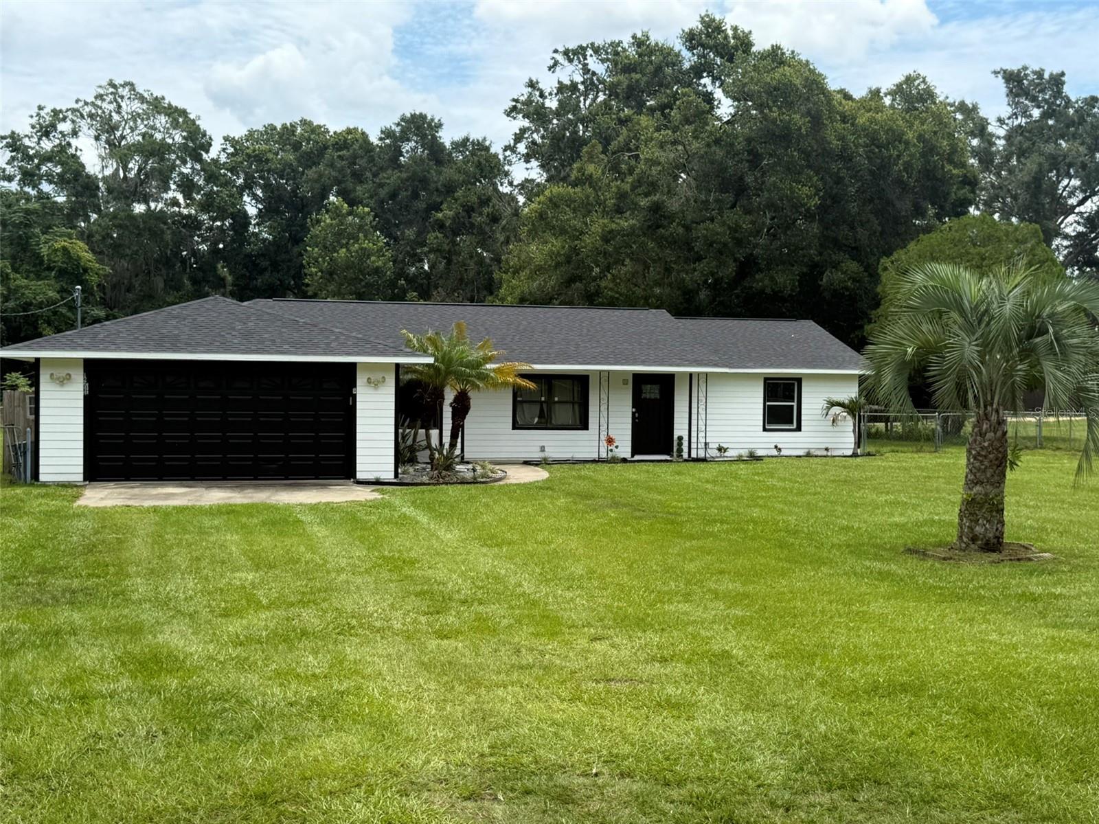 Welcome to this charming 3-bedroom, 2-bath single-family home nestled on an oversized .71-acre lot! Enjoy the peace of mind with a brand-new roof (2025), septic system replaced (2023), AC (2019), blown in insulation (2024), electrical redone (2024), water heater (2020), water softener (2024) and drain field (2023). Step inside to a well-maintained interior and outside to a huge backyard perfect for entertaining, gardening, or simply relaxing by the above-ground pool. The spacious front yard offers additional curb appeal and room to roam. A new water softener installed in 2024 ensures fresh, clean water throughout the home. Located in a rapidly growing area with exciting new developments and infrastructure all around, this home is ideal for those looking for comfort now and value for the future. No HOA or CDD fees! Don’t miss this opportunity to own a large lot with updates already done! Schedule your showing today!