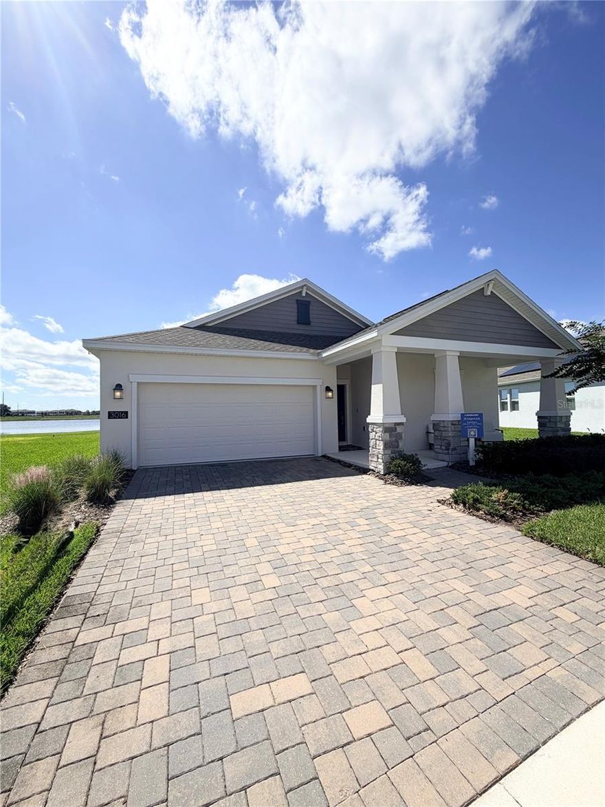 Discover this stunning, never-lived-in former model home in the serene Bridgewalk community!
Set on a spacious lot with peaceful pond views, this single-story residence offers the perfect setting to create your own outdoor oasis. A 5.25 kW solar system helps significantly reduce monthly energy costs.

A welcoming front porch and bright, glass-door entry lead into an open layout featuring a chef-inspired kitchen with 42” upper cabinets, stainless steel appliances, a large center island with seating, and plenty of storage. The kitchen flows seamlessly into the dining and family rooms—ideal for entertaining family and friends.

Relax on the expansive covered lanai overlooking the water, or personalize the space for outdoor living or a fenced yard for pets.

The luxurious primary suite features a coffered ceiling, dual vanities, soaking tub, walk-in shower, private water closet, and oversized walk-in closet. Spacious secondary bedrooms and bathrooms provide comfort for family or guests.

Bridgewalk offers an exceptional lifestyle with resort-style amenities, including a clubhouse, fitness center, lap and leisure pools, BBQ area with built-in grills, picnic pavilion, dog park, playground, pickleball and volleyball courts, and a private boat launch. Lawn maintenance is included, allowing for easy, low-maintenance living.

Zoned for Voyager K–8 and Tohopekaliga High School, residents enjoy access to some of the area’s top-rated schools. Ideally located just minutes from Lake Nona, Medical City, SR 417, and the Florida Turnpike, Bridgewalk combines a peaceful neighborhood atmosphere with convenient access to premier shopping, dining, and entertainment.

Don’t miss your chance to own a nearly new, feature-rich home in one of St. Cloud’s most sought-after communities—schedule your private showing today!