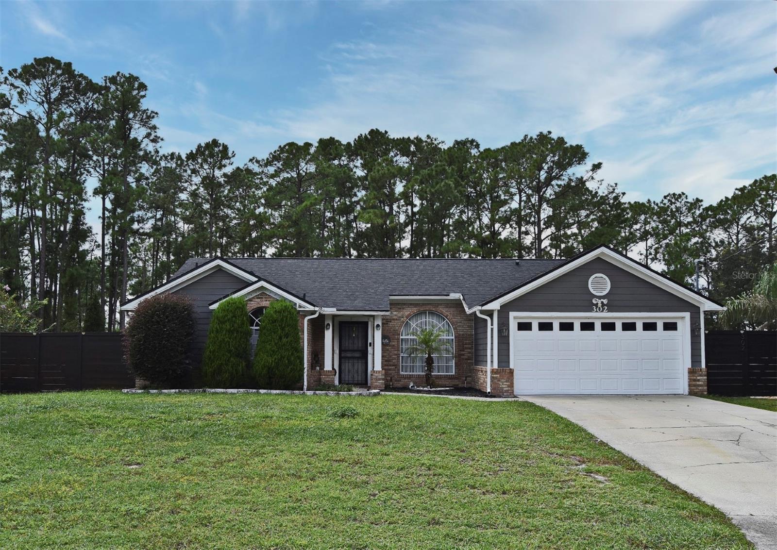 3/2 On almost half an acre, This 1684 Square foot under air property has a large fully fenced backyard with One Large porch for entertaining. Split Bedroom Concept. Open concept Kitchen/Family Room with eat in space in the kitchen. Family Room Furniture, Kitchen table and Stools, Bedroom 2- and 3-Bedroom Sets will all convey with the rental.