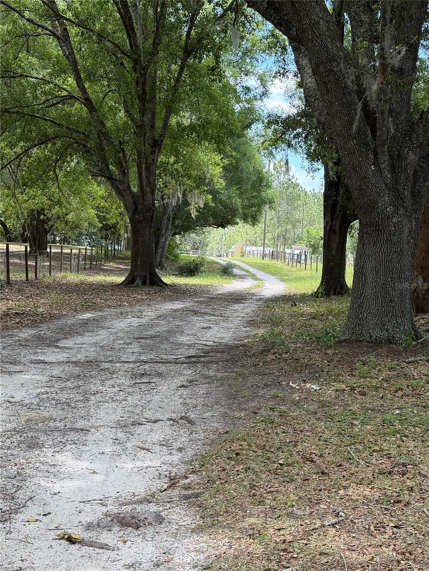 Fresh Air & Country Living! A private driveway welcomes you to this peaceful country retreat nestled beneath a majestic oak tree. Situated on 1.65 fully fenced and gated acres with No HOA, this charming 2-bedroom, 2-bath home is move-in ready. The true value, however, lies in the land and its endless potential. Whether you’re looking to enjoy the existing home, expand, or build your dream estate, this property offers great opportunities. With well, septic, and electric already in place — and impact fees already absorbed — you’re one step closer to making your vision a reality. There’s plenty of room for all your hobbies and outdoor activities. Bring your horses, boat, RV, or ATVs and enjoy the freedom of country living with space to roam. Conveniently located with quick access to I-4, Disney, shopping, dining, and everyday conveniences, this property offers the perfect balance of privacy and accessibility.