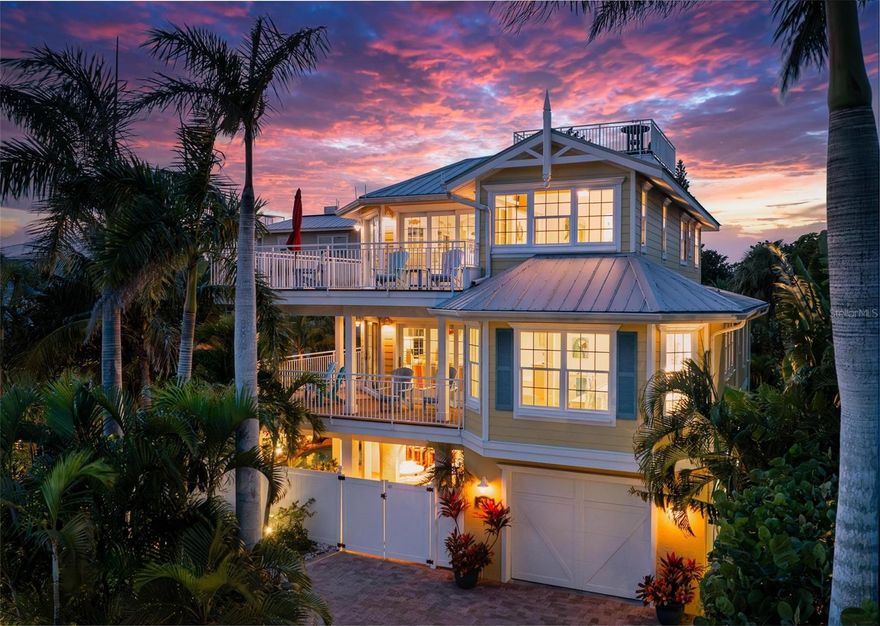 From sunrise to sunset, stunning Gulf views throughout the house. One of the most outstanding features of this property is the expansive rooftop deck—an irreplaceable amenity due to current height restrictions. From this vantage point, take in breathtaking Gulf sunsets, views of the Sunshine Skyway Bridge, and sweeping 360-degree panoramas of the island and surrounding waters. The elevated position of the street further enhances views and peace of mind. The home was thoughtfully designed by award winning architect Emily Anne Smith. The floor plan with four bedrooms, including two luxurious primary suites. Every bedroom features a private en-suite bathroom, complemented by two additional  half bathrooms for a total of six bathrooms. A separate washer and dryer add convenience. The layout is designed to maximize natural light and capture views from sunrise to sunset. Both living levels feature wrap around decks with large seating and lounging areas. The second living level hosts a spacious primary suite with heated bathroom floors, a jacuzzi-style soaking tub, large
shower, and dual vanities. This level also includes two additional en-suite bedrooms, plus a comfortable living area with a half kitchen featuring a sink, refrigerator, microwave, toaster oven, ample cabinetry, and a 48-bottle wine cooler—perfect for guests and family seeking privacy and independence. The third living level showcases an open-concept design with soaring ceilings, where the main kitchen, dining, and living areas all face the Gulf. Enjoy spectacular sunset and skyline views from nearly every angle. This level also features a second primary suite with a king bed and spa-like en-suite bathroom, a separate half bathroom, office workspace, and direct access to the rooftop deck. Outdoor living is equally impressive, highlighted by a resort-style pool with rock waterfall, jet stream fountain, jacuzzi jets, auto-fill system and mature tropical landscaping. A six-foot privacy fence surrounds the property. Entertain with ease at the covered tiki bar equipped with sink, refrigerator, TV, stereo, plus multiple shaded and sun-soaked seating areas. Additional features include a large garage accommodating 2–3 vehicles with 9-foot ceilings, extensive storage, workbenches, elevator, impact-rated PGT windows and doors, metal roof, low-maintenance stucco and Hardie plank exterior, heated slate kitchen floors, plus slate in entrance and storage room, bamboo flooring throughout the rest of the house, Hunter Douglas blinds, and the home is offered fully furnished and move-in ready. The home also features a monitored security system, smart thermostats and an Artificial Intelligence (AI) Camera System with DVR. Never rented, yet zoned for weekly rentals. No hurricane water intrusion in 2024. A truly rare offering on Anna Maria Island on one of the highest elevation and quietest streets with a deeded beach access.