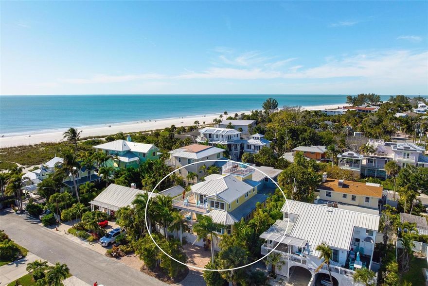 Under contract-accepting backup offers. From sunrise to sunset, stunning Gulf views throughout the house. One of the most outstanding features of this property is the expansive rooftop deck—an irreplaceable amenity due to current height restrictions. From this vantage point, take in breathtaking Gulf sunsets, views of the Sunshine Skyway Bridge, and sweeping 360-degree panoramas of the island and surrounding waters. The elevated position of the street further enhances views and peace of mind. The home was thoughtfully designed by award winning architect Emily Anne Smith. The floor plan with four bedrooms, including two luxurious primary suites. Every bedroom features a private en-suite bathroom, complemented by two additional  half bathrooms for a total of six bathrooms. A separate washer and dryer add convenience. The layout is designed to maximize natural light and capture views from sunrise to sunset. Both living levels feature wrap around decks with large seating and lounging areas. The second living level hosts a spacious primary suite with heated bathroom floors, a jacuzzi-style soaking tub, large
shower, and dual vanities. This level also includes two additional en-suite bedrooms, plus a comfortable living area with a half kitchen featuring a sink, refrigerator, microwave, toaster oven, ample cabinetry, and a 48-bottle wine cooler—perfect for guests and family seeking privacy and independence. The third living level showcases an open-concept design with soaring ceilings, where the main kitchen, dining, and living areas all face the Gulf. Enjoy spectacular sunset and skyline views from nearly every angle. This level also features a second primary suite with a king bed and spa-like en-suite bathroom, a separate half bathroom, office workspace, and direct access to the rooftop deck. Outdoor living is equally impressive, highlighted by a resort-style pool with rock waterfall, jet stream fountain, jacuzzi jets, auto-fill system and mature tropical landscaping. A six-foot privacy fence surrounds the property. Entertain with ease at the covered tiki bar equipped with sink, refrigerator, TV, stereo, plus multiple shaded and sun-soaked seating areas. Additional features include a large garage accommodating 2–3 vehicles with 9-foot ceilings, extensive storage, workbenches, elevator, impact-rated PGT windows and doors, metal roof, low-maintenance stucco and Hardie plank exterior, heated slate kitchen floors, plus slate in entrance and storage room, bamboo flooring throughout the rest of the house, Hunter Douglas blinds, and the home is offered fully furnished and move-in ready. The home also features a monitored security system, smart thermostats and an Artificial Intelligence (AI) Camera System with DVR. Never rented, yet zoned for weekly rentals. No hurricane water intrusion in 2024. A truly rare offering on Anna Maria Island on one of the highest elevation and quietest streets with a deeded beach access.