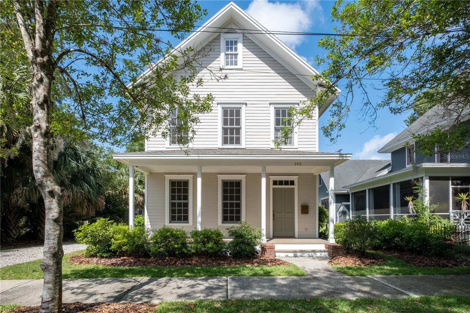Rare newer construction in the historic Duckpond neighborhood with a NEW roof! Built in 1998, this four-bedroom, three-bath home was thoughtfully constructed with details that embrace the classic feel of a historic home. Features include hand-selected red oak floors, tall baseboards, 9-foot ceilings, all wood windows, two-part crown moldings and a traditional raised porch on locally-sourced brick pillars. The brick also completes the foundation surround, the massive outdoor chimney and outdoor patio. The welcoming and deep entrance hall has a beautiful oak staircase with a Karastan runner. The living room includes a fireplace and architectural trim details by noted architect Jay Reeves. The downstairs includes a formal dining room, spacious kitchen and laundry closet. There is also a downstairs bedroom ideal for a guest room, study, den or office with French doors leading to the brick terrace. On the second floor balcony, there is a lovely bookcase that is perfect for treasures. The owner's suite includes a full bath with Jacuzzi tub, walk-in closet and a study nook. There are two more bedrooms upstairs and a hall bathroom. All of the bathrooms are simple and clean. Built by Dibros Construction, this house was built to last with durable Hardiboard siding. The house was situated far to the north on the lot, leaving plenty of room on the south for a detached garage or addition. Architectural plans available for possible additions. Other features include a security system, 4-zone irrigation system, a custom storage shed and mature landscaping with a variety of Florida friendly plants and palms. Newer HVAC, complete repipe in 2019 and entire interior painted in 2022. A short ride to the University of Florida and walking distance to downtown Gainesville, parks and shopping.