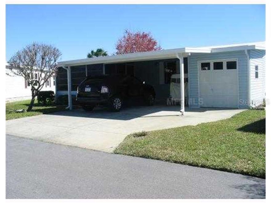 Own your own land! Resort style living for an affordable price! Run your own life as this is a community owned by the residents and we make the decisions (I live here!) The HOA includes everything except your electric bill and lawn mowing! Has a front lanai that allows you to enjoy watching the world go by!  Golf cart is included, and all furniture is staying along with the washer and dryer (inside laundry room a plus). Enjoy 18 holes of golf for just $3 green fees in this Gated, Golf Community, located just outside of the city, and approx. 1.25 hrs. from either coast. Great access to Disney, Legoland, and BOK Tower, just to name a few local attractions. In this very friendly, resident-owned community, you can be as active or inactive as you choose! Gatherings at the private Pub or the Community Room, fishing & boating on Lake Henry (dock within the community), gardening, tennis, golf, shuffleboard, pickle ball, horseshoes, swimming in the heated pool, enjoy the hot tub or the 24/7 workout room! Contact agent for this community's website address and documents, including Rules/Regs, Application, Financial, and Bylaws. HOA INCLUDES A DVR PLUS 2 HD CABLE BOXES AND INTERNET! (Minimum age in this 55+ community is 50 years old)