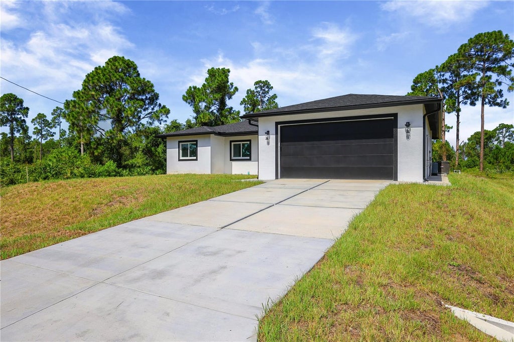 Photo of 828 Genoa Avenue S, Lehigh Acres, FL 33974 (MLS # C7528591)