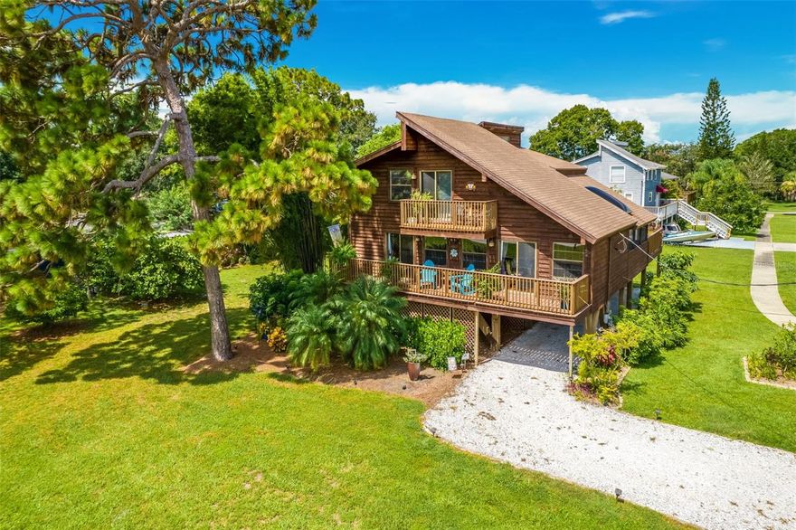 **Property includes the adjacent buildable lot!** Nestled within the captivating landscape of Oldsmar, this exceptional cedar stilt home stands as a true testament to charm and elegance. Situated a mere stone's throw away from the sprawling beauty of the 15-acre R.E. Olds Park, this meticulously maintained residence presents an unparalleled living experience. Gracing an expansive .39-acre homesite which includes an additional buildable 50x150 lot, this property captures the essence of Florida living at its finest. Enveloped by a serene tableau of Pines, Palms, and Bamboo, this idyllic haven is a symphony of natural beauty. The main floor unfolds in an open layout, where abundant natural light dances through an array of windows, illuminating the gleaming wood flooring that guides your journey. The main level is replete with a well-appointed kitchen, a welcoming dining area, a spacious living zone, a utility room, an updated powder bathroom, and not one, but four captivating outdoor patios. The gourmet kitchen is a masterpiece of design, boasting Espresso Shaker soft close cabinetry that blends seamlessly with the island, complete with a snack bar, Quartz countertops and stone backsplash. Upgraded pendant and recessed lighting cast a warm glow on the Bosch stainless appliance package, featuring a smooth electric cooktop and a wall oven with a separate convection oven. French Doors beckon you to a sprawling patio that is the heart of this home. A sanctuary enveloped in nature, it is an oasis of tranquility—perfect for both entertainment and relaxation. An adjacent covered screened patio offers its own charm and privacy, featuring a hot tub, sitting area, and a skylight. A third outdoor patio on the main floor is the perfect place to enjoy a cup of coffee and watch the sunrise. Ascending to the third level, you'll discover three bedrooms graced by vaulted ceilings. The master suite offers a walk-in closet, an ensuite bathroom with a walk-in shower complete with a seat and skylight. A fourth outdoor patio provides a glimpse of Tampa Bay, adding to the allure of this retreat. The guest bedrooms are bathed in natural light, adorned with ceiling fans for comfort. The guest bathroom showcases a tub with a shower arrangement, catering to both convenience and style. The ground level of this property caters to practicality and leisure alike, boasting covered parking, a gazebo, and a workshop. Abundant storage is available for golf carts, paddleboards, canoes, boats, and all your cherished recreational gear. For added peace of mind, a Ring doorbell and a security system ensure a sense of security. The irrigation system is connected to reclaimed water providing additional cost savings. The owner is paying under $500 annually for flood insurance. In addition to its remarkable features, this residence is nestled within the heart of Oldsmar—a golf cart-friendly community that offers access to a public boat ramp, kayak launches, fishing piers, parks, playgrounds, trails, bars, restaurants, and shopping. Recently ranked the 8th safest city in Florida, Oldsmar welcomes you with open arms and a sense of community that is second to none.