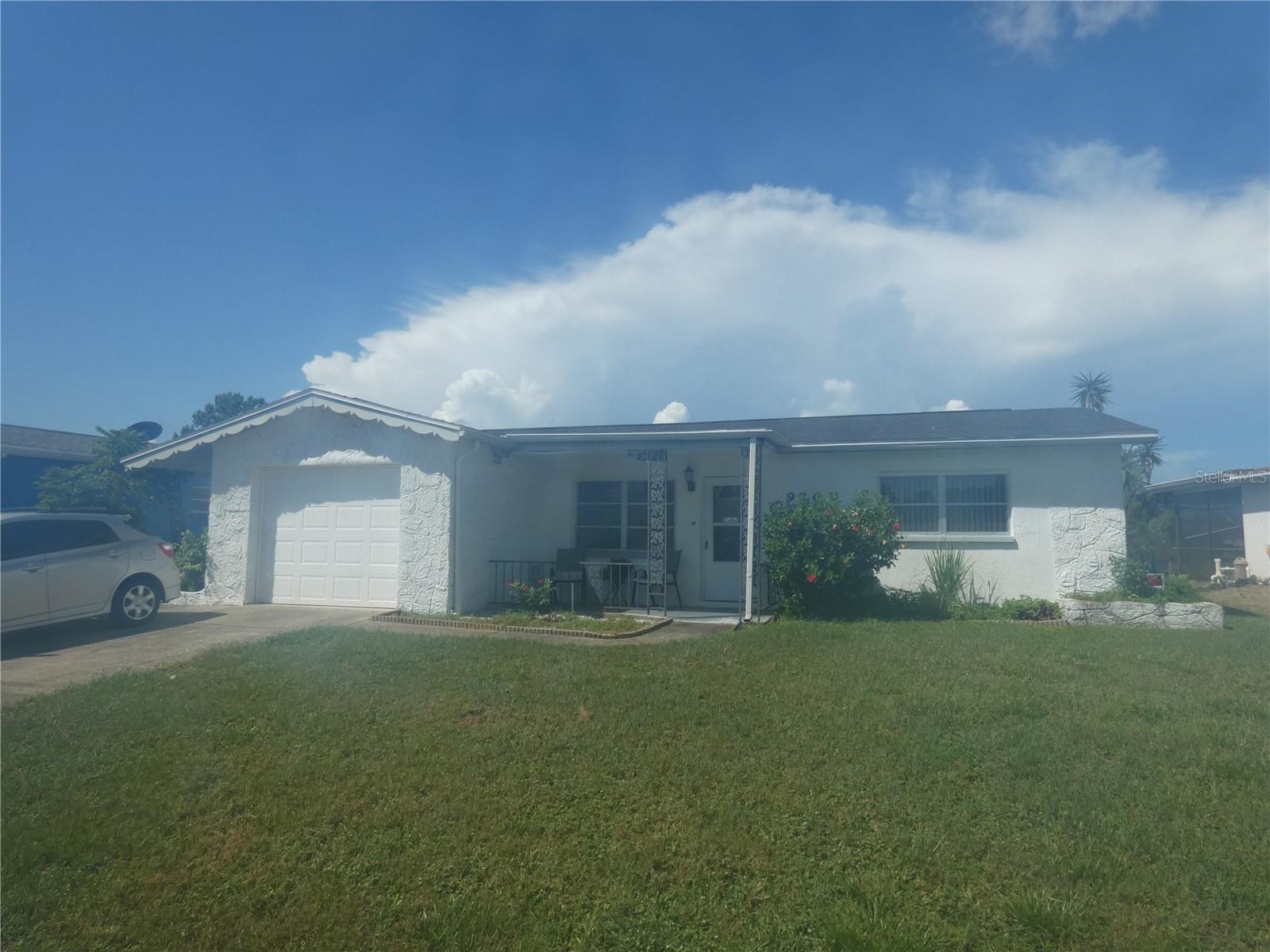 Welcome to Florida and beautiful sunset paradise on Lake Christine with your own Saltwater pool and screen enclosed recreational area! This 2 bedroom, 2 bath awaits your personal touches to make it your own. Primary bedroom has walk in closet and bathroom & shower. Florida room features beautiful views of the lake and pool. Flat roof and rear soffit was done in 2023, shingle roof 2019, seawall 2011, A/C 2014. Many bookshelves are attached. See this home today. Great location, close to beaches, parks, shopping, Tarpon sponge docks and easy commute via the Suncoast Parkway to the Tampa Airport, Tampa and Clearwater.