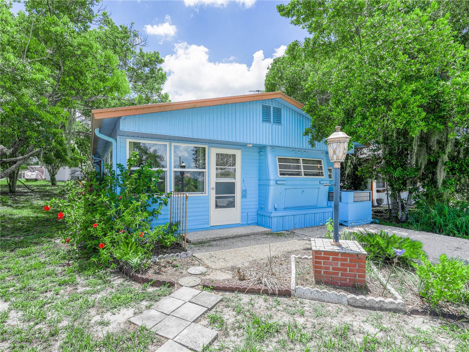 Whoa, this sounds too good to be true - but it is! Well maintained and furnished, this one bedroom home is located in the premier 55+ gated community of Saddlebag Lake Resort, where you OWN the land. The ground floor main living area includes a spacious living and dining room combination, complete with a sleeper sofa for your overnight guests and an electric recliner for maximum t.v. watching comfort. Upstairs you'll find a very functional kitchen, a breakfast nook, a cozy bedroom, a recently updated bathroom and a sizable laundry room. Walk through the sliding glass door downstairs and you're in the large screened porch where you'll enjoy entertaining friends, plus there's an adjacent storage shed. Surrounding trees provide welcome shade and afford the home added privacy, and there are two driveways so you'll always have a place to park. The home has recently been inspected and has been determined to have all the proper tie-downs. The low HOA includes your water, sewer and trash pick up, as well as use of all the amenities, including a sparkling community pool; hot tub; tennis and pickleball courts; horseshoe pits; a rec room with fitness equipment, pool tables and saunas; shuffleboard courts; a dog park, driving range and a library. Of course, you'll have access to Saddlebag Lake, where the fishing is great! Not to mention the clubhouse where you can participate in planned activities, and a beach house that you can use free of charge for private parties, just reserve it. There's truly something for everyone here, so don't wait another minute, call to schedule your private tour now!