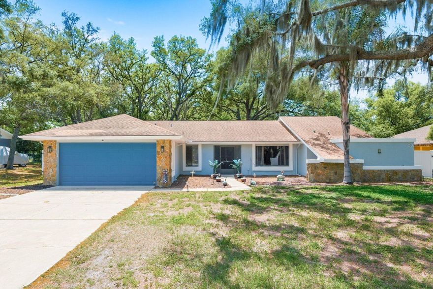 Rare backyard flexibility in Spring Hill: fully fenced, mature oaks, and double-gate side access for RV, boat, trailer, or toy parking. This bright and inviting home is designed for buyers who value usable outdoor space, privacy, and everyday functionality. The large backyard is enclosed with vinyl privacy fencing and offers a peaceful setting with mature oak trees, generous green space, and room to relax, entertain, garden, or enjoy the Florida outdoors. Inside, vaulted ceilings, a split floor plan, an open kitchen, and natural light throughout create a comfortable and practical layout. Located near everyday shopping, dining, parks, and recreation, with easy access to Weeki Wachee Springs, kayaking, boating, Hernando Beach, and the outdoor lifestyle of Florida’s Nature Coast. A standout opportunity for buyers looking for more than just a house, this property offers privacy, flexible parking, and a backyard lifestyle that is hard to duplicate at this price point.