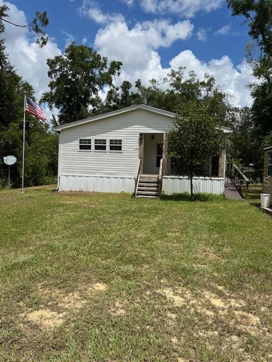 This 4 year old home is tucked away on just over 1/4 of an acre in Gilchrist County but less than 5 minutes to Newberry. It is wheelchair accessible with 3 large bedrooms and 2 baths. This is a Farm House style home with a lot of shiplap throughout. The kitchen has a huge gas range and hood with an island that is 10 ft by 4 with plenty of room for guests to eat at. Please note that all the kitchen cupboards have custom drawers that pull out for easy access. There is a sliding barn door to close off the kitchen to the butler pantry where you will find the microwave and the beverage cooler. This room then leads to a very large laundry room that which serves as space for a freezer. The home flooring is beautiful vinyl plank throughout which make the living room and dining room look very elegant and spacious. Going down the hallway you will see a cubby hole desk with 3 drawers and countertop. This is a wonderful place to keep your bills/receipts which stop cluttering the kitchen counter! The guest bath has a tub/shower with a Formica vanity counter top. Two good size bedrooms lead to the master bedroom suite which takes up the entire back of the home. The bedroom is 14.5 X 15.5 which leaves plenty of room for a king size bed and furniture. A stand alone sunken tub, enormous shower, and dual counter sink make this a bath to envy. The property is entirely fenced with wire fencing and has an electric gate entrance. The 12 x 20 shed remains.