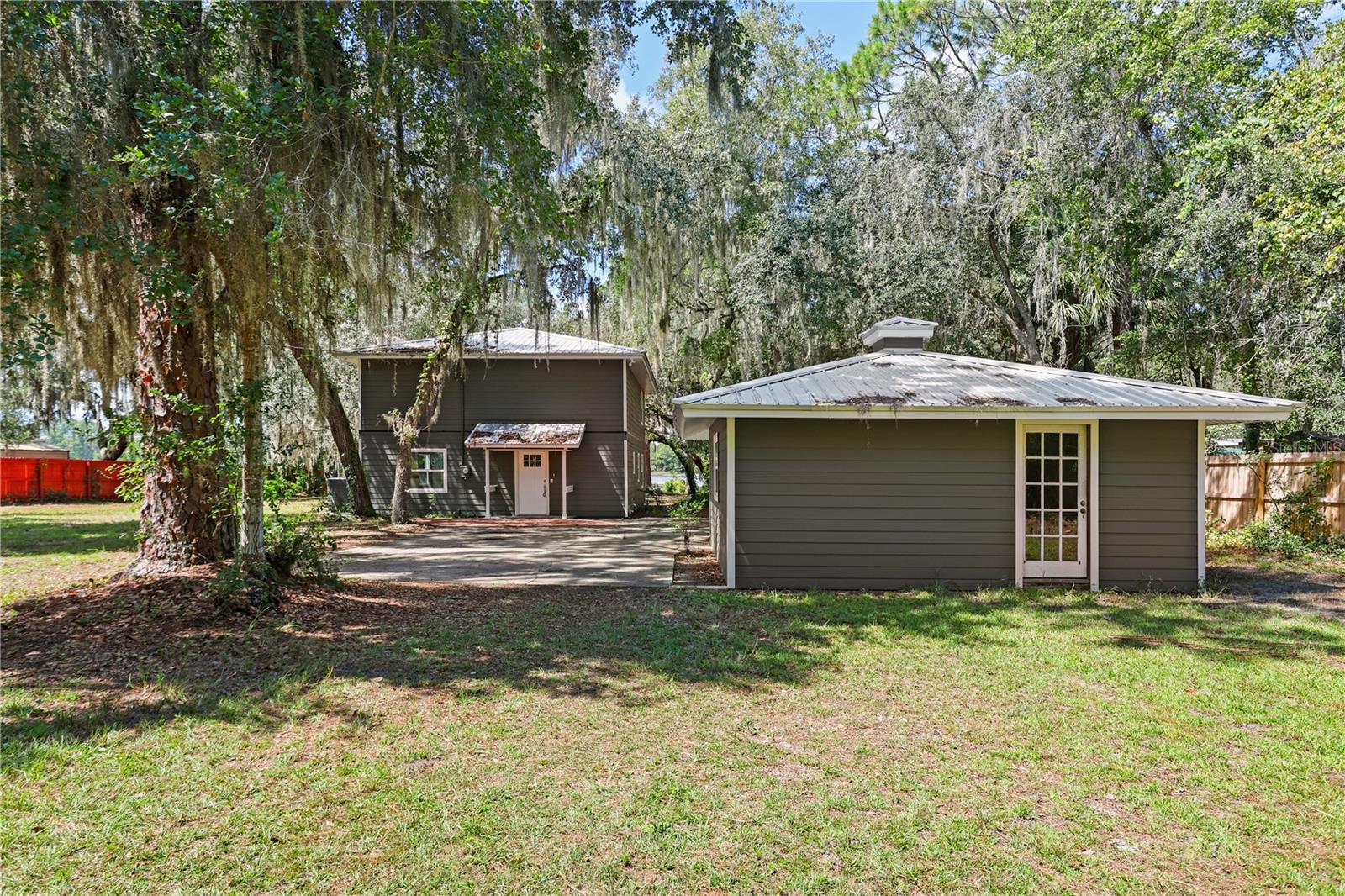 Lakefront living awaits in this 2-bedroom, 2.5-bathroom home featuring 1,904 sq. ft. of living space and sits on just over 3 acres with direct frontage on Higginbotham Lake. The property includes an unattached garage/workshop, metal roof, updated interior, and mature trees offering shade and privacy.
Enjoy fishing, boating, or relaxing on your private stretch of lakefront from your dock while being conveniently located near Ocala, Palatka, and Gainesville. With no HOA fees and low taxes, this property is ideal as a primary home, weekend getaway, or investment.