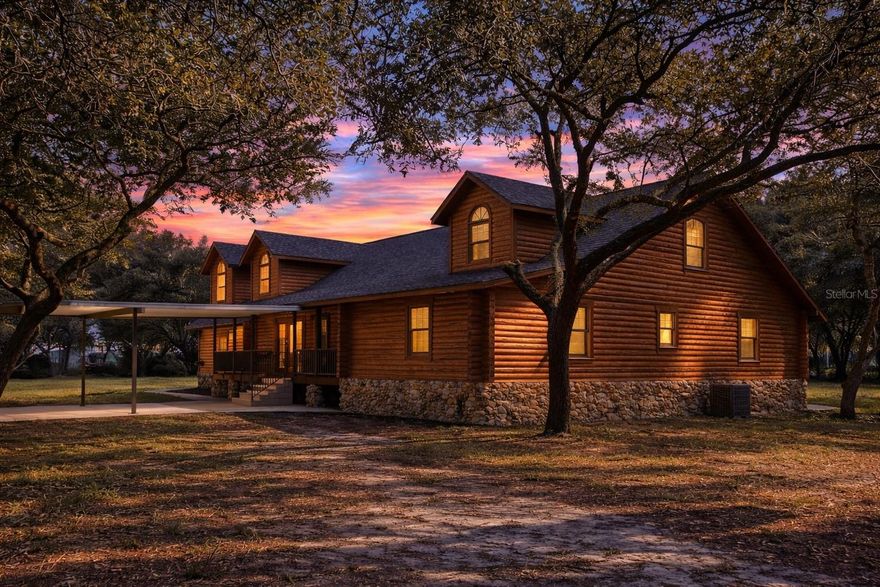 One or more photo(s) has been virtually staged. DISCOVER THE SERENE LUXURY OF THIS METICULOUSLY HANDCRAFTED CYPRESS LOG CABIN, your private and fully fenced 6.11-acre estate in Sorrento, FL. Being offered for the first time, this unique, one of a kind 4,067 SF residence blends rustic charm with modern sophistication, featuring five spacious bedrooms, each with its own private bathroom for ultimate comfort. A bedroom upstairs and a bedroom downstairs have no built-in closet. Pass through the entryway to find Australian Pine floors that flow throughout, while the downstairs primary suite offers a warm Walnut floor, two walk-in closets, and an ensuite with a garden tub and walk-in shower. The heart of the home is the comfortable living room, anchored by a magnificent stone wood-burning fireplace. Culinary enthusiasts will love the country-style eat-in kitchen, boasting extra-thick granite countertops and 42" solid wood cabinets. Sharing the fireplace, a separate sitting room opens to a massive 8’x40’ covered back deck, perfect for relaxing in the gentle Florida breeze. Leading from a spacious bedroom upstairs, a custom-made walkway leads to a versatile landing currently being used as a billiards/game area and a second master bedroom with its own walk-in closet and full bath. Functional highlights include an interior laundry room with a half-bath leading to an oversized 3-car garage. Meticulously maintained, the home was raised 3 feet for longevity and features a New Roof installed in July 2025, an exterior freshly sealed and pest treated in 2025, a New Hot Water Heater in 2025, dual A/C systems from 2022 and 2019, and a New Drain Field from 2020. This property is zoned A-1 with no HOA, offering unlimited potential for an accessory dwelling, gardening or horses & farm animals or use as a boutique Bed & Breakfast with a special exception. Enjoy unparalleled peace and privacy while remaining minutes from the 429, Mount Dora, Orlando, and Florida's famous beaches. This unique, one-owner cypress sanctuary is a rare find — experience it for yourself today!