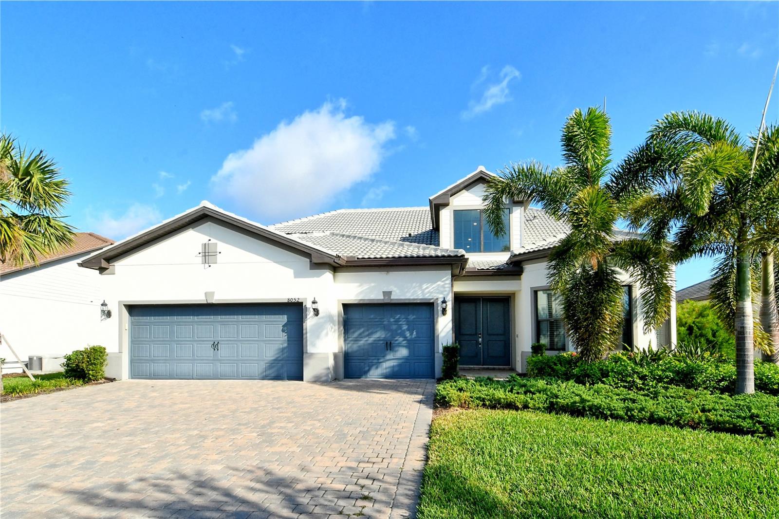 Grand residence on Grande Shores! This home is located in the Shoreview neighborhood in the Waterside Place area of Lakewood Ranch. Built in 2021, this floorplan features a loft for flexible living. This lakefront home has four bedrooms and a flex space with built-in bar seating currently being used as a media room. This home boasts over 4,000 square feet of living space, with an luxurious extended lanai with outdoor kitchen.
The open floor plan with high ceilings, oversized impact windows, and impact glass sliders flood the space with natural light. The kitchen is a dream with a large island, breakfast bar, pendant lighting, stainless steel appliances, quartz countertops, and a walk-in pantry complete with high end shelving. Split bedroom floorplan grants privacy for all bedrooms. The primary suite has tranquil pool and lake views, a tray ceiling, and a walk-in closet with built-in shelves. Going upstairs, you will find a loft perfect for a game area or another living space. The loft is complete with the fourth bedroom and fourth full bathroom.
The beautiful lanai features a Clearview screen around the luxurious, heated, saltwater infinity edge pool. This pool comes complete with a sun shelf, waterfalls, and a large built in spa. The lanai has access to a half bath for convenience: keeping wet swimsuits out of your home. Your outdoor oasis is complete with an equipped kitchen featuring a Blackstone grill, television, icemaker, and refrigerator drawers. This property offers the potential to add a dock. Plenty of parking and storage with a wide driveway and extended three-car garage with epoxy flooring. Seller is offering $10,000 in seller concessions for the buyer to upgrade flooring to their taste.
Resort style amenities await you at Shoreview at Lakewood Ranch Waterside. This community offers a clubhouse, an outdoor bar, grilling areas, heated community swimming pool, spa, fitness center, a lakefront deck, tennis and pickleball courts, fishing, walking trails, a beach area, and much more. Not only do you have amazing amenities in your neighborhood, you are also near everything Waterside Place has to offer. Waterside is an amazing city center with restaurants, shopping, Sunday Farmer's Market, Ranch Nite Wednesdays with food trucks and endless activities. Easy access to University Town Center, I-75, and about 14 miles to the nearest beach (Lido Key). This home puts you in the center of it all!