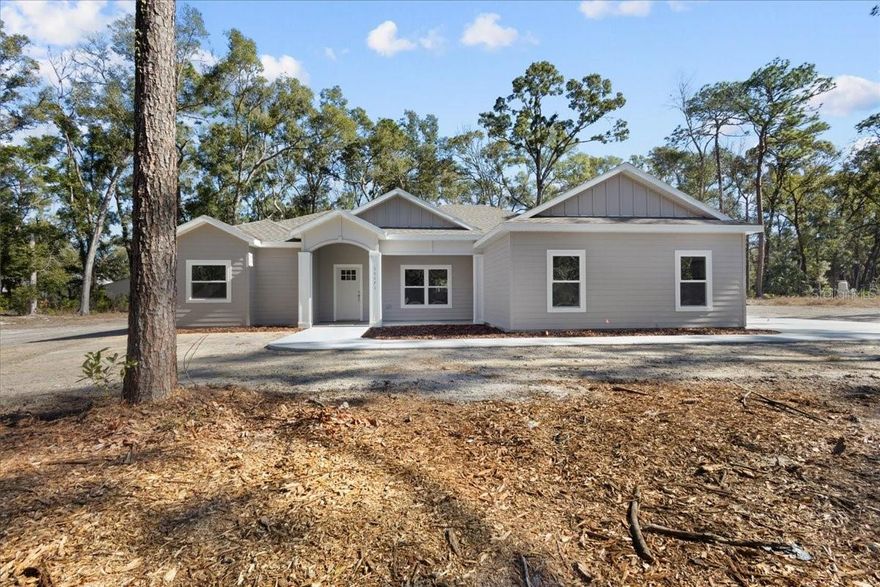 Brand New 2025 Custom Wade Home located in the most desirable Buck Bay Subdivision. A perfect floor plan coming in at 1660 H/C Sqft , 4 bedrooms/2 bathrooms on one full acre with the perfect tree buffer offering privacy. Buck Bay is known for its wonderful location being a short drive to town, right up the road from The Chiefland Golf and Country Club, the Suwannee River and amazing Manatee Springs State Park. A wonderful community perfect for families and folks of all ages AND a very minimal HOA coming in at $75 annually. Take advantage of the dropping interest rates and get you a brand new home in 2026. As you enter this property you will love the spacious 1 acre lot, concrete drive leading you to the gorgeous home. A beautiful custom entry that leads you to the bright open floor plan, gorgeous tile floors that look like wood throughout the home and then carpets in the bedrooms for extra comfort. A large living room space, dining room with view of the back yard and spacious kitchen with gorgeous quartz countertops and perfect tile backsplash. Laundry room with closet for storage right off the 2 car garage and washer and dryer INCLUDED! True split plan with 2 bedrooms on one side and additional bedroom on the other side with the oversized master bedroom! Master bathroom with dual vanities , soak tub and stand up shower. A thoughtful color scheme throughout that is calm and neutral perfect for any decor and additional flush mount lighting throughout. A peaceful patio partially covered out the dining room door. 3 zone auto irrigation system with misters around the home. You can be rest assured this home was built with passion and quality and ready for its forever home owner! All loans accepted call today!