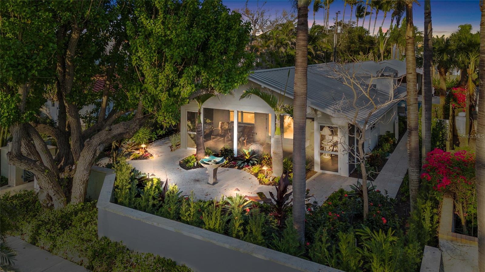 LOCATION LOCATION LOCATION-Walk to everything from this truly exquisite 3 bedroom, 2 ½ bathroom Gilchrist Cottage in the heart of the “Historic District”. Loaded with mid-century charm, updated professionally with modern coastal contemporary influence throughout, all nestled onto a deep 50’ by 150’ lot. The property is being beautifully remodeled nearly new and will be delivered Designer furnished for immediate use! This delightful home offers a very private swimming pool area tucked behind privacy fencing covered with fragrant Jasmine, among just planted new lush and additional landscaping. A standing seam metal roof protects the Cottage along with back-alley access to a large, covered carport. The main living area provides a Great Room concept with Philippine Shellstone flooring throughout and a comfortably spacious 10’ by 28’ old fashioned front porch facing the Gulf of Mexico! Estate Wall, extensive pavers, and luminous night lighting offers a very special ambiance at this superb location. A rare opportunity to own in this very limited heart of the Village