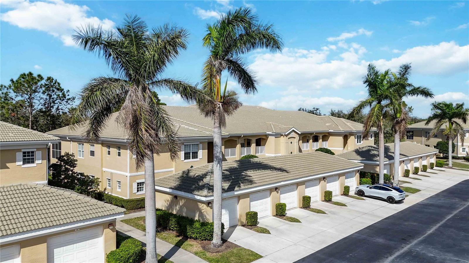 Immerse yourself in the luxury condominium/maintenance free lifestyle that lives like a single family home. With over $100,000 in upgrades and improvements in this professionally designed showstopper, you'll be wowed by this ground floor, corner unit in Grand Oak at Tara. When you walk through the front door, you are instantly greeted with an abundance of natural light as you delight in the open floorplan that showcases the beautiful and private view from the lanai. You'll make note of the crown molding, upgraded baseboards throughout, and beautiful laminate flooring. Enjoy the fresh interior paint, new light fixtures in every room, California wood plantation shutters adorning every window, and even all new switches, outlets and covers. No detail was overlooked in this exquisite home. Find your way to the kitchen that boasts solid cherry wood cabinetry and new stainless steel appliances. You'll enjoy meal preparation on the spacious island as you gaze outside to your serene pond view. Pull out drawers can be found in each of the bottom cabinets for easy storage and access. Both bathrooms have been masterfully designed and upgraded with solid cherry wood cabinetry, new tile, toilets, lighting, plumbing fixtures and mirrors. Have peace of mind knowing that the HVAC and water tank have all been replaced. Even more, the entire home is now equipped with full smart home technology so you can operate the thermostat or garage door from an app on your phone! The primary bedroom is a peaceful retreat with like-new carpet, a large en-suite and walk-in closet. The flexible third bedroom is large enough to accommodate bedroom furniture as well as the beautiful built-in desk equipped with book shelves and file drawers for those wanting a home office. With NO mandatory golf fees and the community pool just steps from your front door, you'll find beauty, tranquility and convenience in this gorgeous home close to shopping, restaurants, Jiggs Landing (Manatee County nature preserve), and I75. Owners in Grand Oak also have the privilege to enjoy Tara's amenities including their heated pool and spa, pickle ball and tennis courts, and use of the clubhouse! The option to purchase Turnkey Furnished is also available---ask for more details and schedule your private showing today! Full list of upgrades and improvements is available.