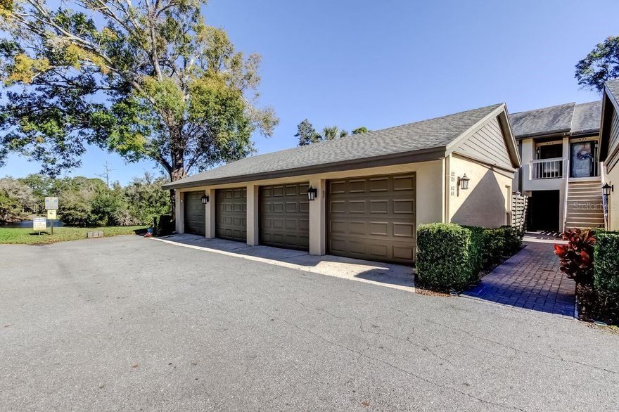 Welcome to the peaceful condo community of Eagles Glen. This beautifully renovated second-floor condo is immaculate and features 2 spacious bedrooms, 2 full bathrooms and large screened-in lanai. Nestled in the highly desirable area of Countryside, this home offers the perfect blend of comfort, style, and convenience, with the added peace of mind that it is high and dry with no flood insurance required. The condo boasts luxury wood flooring throughout, complemented by sleek tile in the bathrooms. The spacious living area is enhanced by a cozy fireplace, and the home features vaulted ceilings, ceiling fans, and recessed lighting. The kitchen is a chef's dream, showcasing soft-close cabinetry, stainless steel appliances and beautiful Granite countertops. The primary bedroom features a large walk-in closet and direct access to the screened-in lanai. as well as an en-suite bathroom. There is an inside laundry area including a washer and dryer. In addition, the added bonus of a one-car garage with attic storage! The low-maintenance lifestyle is further enhanced by the community pool and tennis/pickleball court. The HOA fee includes almost everything: cable, internet, water, trash, sewer, lawn care, exterior maintenance, pool maintenance. The property is adjacent to the renowned Chi Chi Rodriguez Golf Club, and just minutes away from the Countryside Country Club. The location is unbeatable, situated in the heart of Countryside and close to top-rated schools, restaurants, shopping, concert venues, sporting events, major airports, world-class beaches, and a variety of golf courses. The charming towns of Dunedin, Safety Harbor, Palm Harbor, and Oldsmar are also just a short drive away. Don't miss out on this exceptional opportunity to own a stunning condo in one of the most desirable locations in the area. Schedule your private showing today!