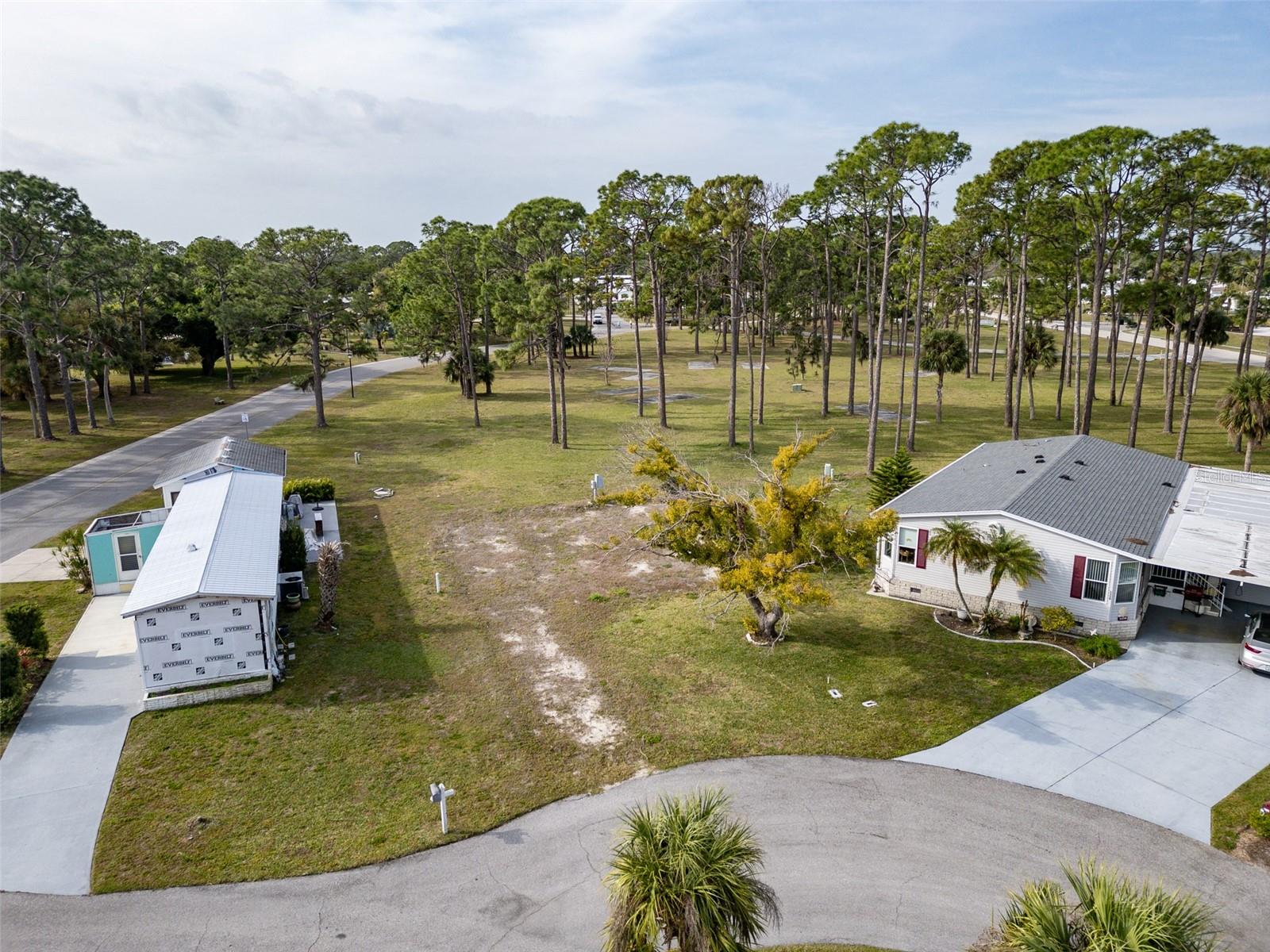 One Of Holiday Park's BEST Lots Available! Beautiful Park View Out The Back And & Quiet Cut De Sac In Front With City Water & Sewer. Holiday Park And Recreation Is NOT An HOA, They Are A Special District. Fees Are Collected On The Property Owners Annual Tax Bill Under Non-Ad Valorem Assessments. The Current Amount Is $1,556.16 per Year. There Are Many Activities To Do In The Park. 14 Shuffleboard Courts 6 Horseshoe Pits 4 Pickle Ball Courts 3 Tennis Courts 3 Bocce Courts 3 Ping Pong Tables 2 Heated Pools 1 Laundry Facility 1 Billiard Room 1 Fitness Center. Just Out The Front Gates Is Great Shopping & Restaurants. The Perfect Lot For Your New Florida Home.