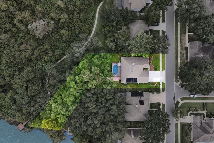 Living beautifully in a Winter Garden neighborhood, just moments from the Roper YMCA and West Orange High, this waterfront home offers something rare: space to breathe, views to get lost in, and quiet luxury. With over 2,800 square feet of thoughtfully designed living space, this four-bedroom, three-bathroom home brings both usefulness and character—starting with a shiplap-adorned front living room and flowing tile floors throughout. Step outside and the world opens up. A sweeping pavered pool deck extends into multiple tiers of outdoor living: a shaded terrace for lounging and dining, and a peaceful firepit-style seating area just steps from the lake. Whether you're sipping coffee in the morning stillness or hosting friends at sunset, the setting does the work for you.
Inside, the kitchen anchors the heart of the home, with crisp white cabinetry, quartz countertops, KitchenAid appliances, and a center island that’s useful on all four sides—practical and beautiful. The formal dining room's arched window lets in the Florida sun, while the office—with French doors, built-in cabinetry, and a full adjacent bath—offers a quiet place to work or host guests comfortably. The primary suite is a personal retreat, complete with a bold feature wall, double closets, a soaking tub, and a walk-in shower—all thoughtfully separated for privacy. Secondary bedrooms are generously sized, and the pool bath is cleverly designed with a split layout that allows for simultaneous use. Add in a large laundry room with a utility sink, a spacious 3-car garage, and mature trees that shade the backyard year-round, and you've found a home that’s as livable as it is beautiful. With lake access just steps away—whether you prefer to keep the shoreline wild or shape it to your liking—this is Florida living at its best, redefined with calm elegance.