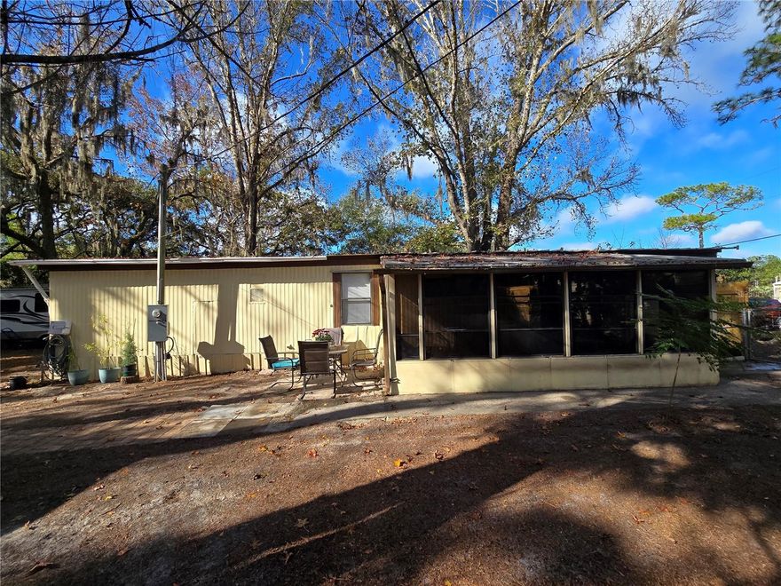 Peaceful Homosassa living on an oversized lot with mature trees!

This 2-bedroom, 1-bath single-wide manufactured home offers 660 sq ft of living space on a 0.38-acre fenced lot in a non-flood zone. Features include a living room, kitchen, washer/dryer hookups in the hallway, and a front porch.

The property has an outdoor garage, multiple storage options, and space to park large toys or vehicles on the side. Mature trees provide privacy and a relaxing, serene setting.
