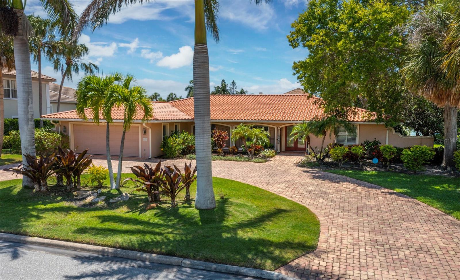 Welcome to your exclusive opportunity to experience life on Bird Key, the epicenter of Sarasota, where the tropical sun-kissed beaches of the barrier islands, the boutiques and dining venues of St. Armands Circle, and the excitement of downtown are just moments from your doorstep. Set on a quiet, welcoming waterfront lot, this property presents a world of possibilities, as you can live in, update or rent the existing 3BR/2.5BA, 2,700+/- sq.-ft. pool home or create your fabulous, brand-new canal-front estate amid some of the region’s finest homes. A stately circular paver drive enveloped by lush mature landscaping frames the façade, as a glass double-door entry leads the way inside to its spacious and open floor plan. The kitchen has been beautifully appointed with all-white accents to contrast the black solid surface countertops and the neutral tones of the tile backsplash. Tile floors flow throughout and create a light, roomy feel, which is further enhanced by a wall of sliders in the main living room opening to the expansive screened lanai with covered seating areas and a large pool. Any option you choose for the future of this property will also be a boater’s dream, set on a calm, navigable canal with ease of access to Sarasota Bay and the Gulf of Mexico from your private dock and boat lift. Bird Key Yacht Club membership available for dining, yachting and tennis.