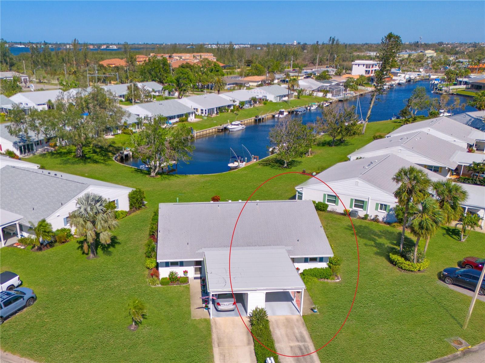 WELCOME TO YOUR COASTAL CANAL FRONT VILLA- Nestled in the heart of a picturesque bayfront community, this nicely appointed & partially furnished residence is ready for your immediate enjoyment. A prime location features water views in front & back with the clubhouse & amenities just around the bend, it's the ultimate Florida lifestyle. MODERN UPGRADES FOR PEACE OF MIND- You'll appreciate the thoughtfully updated features, including a 2024 electrical panel, 2023 Trane AC, 2021 impact windows, 2017 water heater, and fresh paint in summer 2025. SUPERIOR CONSTRUCTION & CONVENIENCE- Enjoy the security of a newer roof with third nails in the roof-wall connectors & solid concrete block construction. A private carport and driveway, along with a 12x5 secure storage unit for electric bikes, beach gear, and sports equipment, add to the villa’s convenience. Plus, guest parking is conveniently located on both sides of the villa. OUTDOOR BLISS- Step onto your spacious 27-foot patio, a tranquil retreat for grilling, lounging, and watching mullet, manatees, and dolphins play in the canal. The expansive lawn offers ample space for bocce ball, croquet, and cornhole, while the carport seating area provides the perfect front-porch atmosphere to take in lake views and vibrant sunset skies. A BRIGHT & INVITING INTERIOR- Inside, abundant natural light and an open-concept layout create an airy and welcoming space, ideal for everyday living and entertaining. Enjoy lovely views from every window. KITCHEN- Designed for both style and function, the updated kitchen seamlessly connects to the dining area and features white raised-panel cabinetry, a closet pantry, generous counter space, a deep double-bowl sink with a gooseneck faucet, and a sleek white appliance suite. The open layout ensures the chef stays connected to the festivities. SEAMLESS LIVING & DINING- The spacious dining and living area blend effortlessly, with a charming chandelier accenting the dining space and coastal-casual furnishings setting the perfect ambiance for relaxation and entertaining. Wall-to-wall windows provide captivating waterfront and nature views. Accessed from both the living room and primary bedroom, the inviting lanai offers a serene retreat—perfect for starting your day with a morning coffee or unwinding in the evening as you enjoy the gentle breeze. SERENE BEDROOM RETREATS- The primary suite, tucked at the rear for privacy, boasts tranquil views, lanai access, a spacious walk-in closet, and an ensuite bath with an updated vanity, lighting, cabinetry, fixtures, and a tub/shower combination with safety bars. The secondary bedroom at the front features a wall of closets, serene lake views, and an adjacent bath with a walk-in shower, updated vanity, cabinetry, and fixtures. EXTRA HIGHLIGHTS- This villa also includes a storm door with a retractable screen, ceiling fans, window blinds, and a tasteful mix of tile & carpet flooring. COMMUNITY HAS IT ALL- clubhouse, banquet room, billiards, ping-pong, library/game room, lakeside veranda; boat docks; heated pool; tennis; pickleball; shuffleboard; bocce ball; spa; sauna; workshop; chip/putting green; walking; butterfly garden; bay front park; kayak launch/storage; bayside pavilion; lakeside gazebo; bird sanctuary; tidal pond; many lakes & spacious grounds of nearly 90 acres teaming with wonderful Florida wildlife; many activities/socials! ENJOY THE BEST- of coastal living with comfort & breathtaking surroundings. Schedule a showing today.