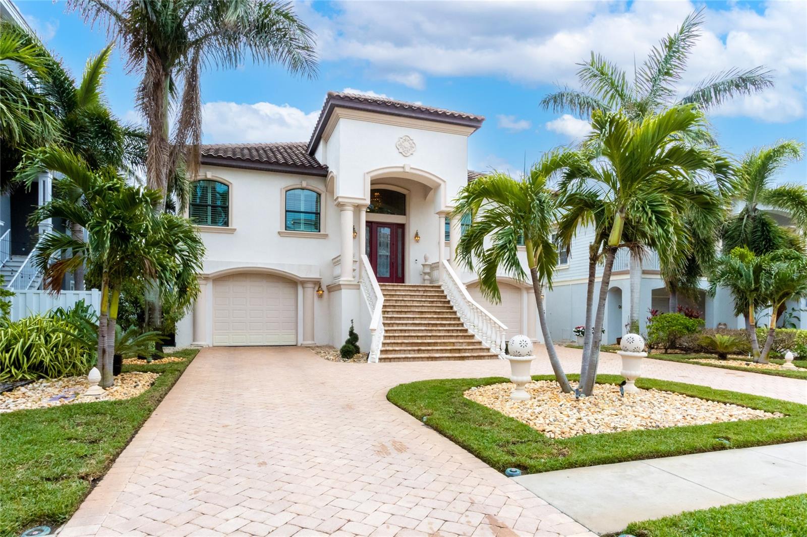 Coastal living at its best! Welcome to an extraordinary move in ready coastal residence, a true masterpiece of design and luxury, located in a prestigious gated community just steps from the pristine sands of the Gulf. This solidly built concrete home offers three bedrooms, three bathrooms, an elevator, and countless custom touches that set it apart. The grand entrance features a black marble foyer illuminated by lighted custom niches and a sparkling amber crystal chandelier. Inside, the 12-foot ceilings create an expansive and inviting atmosphere, enhanced by automated power shades, etched glass accents, and elegant finishes throughout. The home includes a dedicated study, perfect for work or quiet reflection, adding a layer of versatility to the layout. The gourmet kitchen is a chef’s dream with a gas cooktop and high-end appliances, perfectly complementing the home’s sophisticated style. The primary suite is a retreat of unparalleled luxury, boasting a grand entrance, a dazzling chandelier, and a spa-inspired en-suite bathroom. This home is designed for entertaining, with a concrete balcony covered in travertine tiles and an expansive ground level offering generous indoor and outdoor living spaces. A heated saltwater pool and spa are nestled within the professionally landscaped and lighted yard, creating a private oasis. The paver driveway and pool deck add to the home’s exceptional curb appeal. For added convenience and accessibility, the home is equipped with an elevator, ensuring effortless movement between levels. In addition to the exquisite interior and outdoor features, the community offers residents access to a clubhouse with a state of art fitness center, full kitchen, entertainment space, tennis and pickleball courts, a newly added kayak launch, and boat slip opportunities. This home, with its amber crystal light fixtures, custom mosaic flooring featuring onyx, agate, and amber, and countless other bespoke details, provides a rare opportunity to experience the ultimate in luxury coastal living. Don’t miss your chance to own this stunning property surrounded by multi million dollar homes! Seller is ready to make a deal.