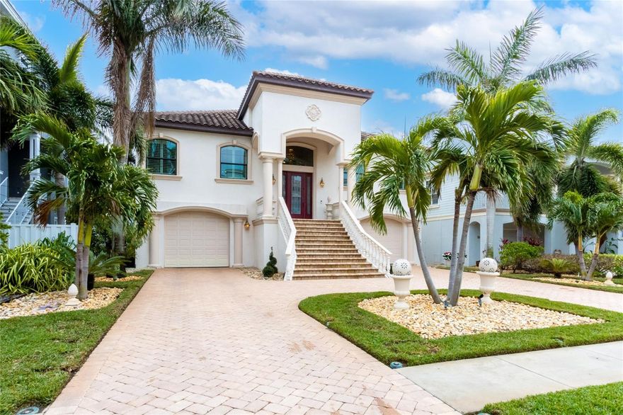 Coastal living at its best! Welcome to an extraordinary move in ready coastal residence, a true masterpiece of design and luxury, located in a prestigious gated community just steps from the pristine sands of the Gulf. This solidly built concrete home offers three bedrooms, three bathrooms, an elevator, and countless custom touches that set it apart. The grand entrance features a black marble foyer illuminated by lighted custom niches and a sparkling amber crystal chandelier. Inside, the 12-foot ceilings create an expansive and inviting atmosphere, enhanced by automated power shades, etched glass accents, and elegant finishes throughout. The home includes a dedicated study, perfect for work or quiet reflection, adding a layer of versatility to the layout. The gourmet kitchen is a chef’s dream with a gas cooktop and high-end appliances, perfectly complementing the home’s sophisticated style. The primary suite is a retreat of unparalleled luxury, boasting a grand entrance, a dazzling chandelier, and a spa-inspired en-suite bathroom. This home is designed for entertaining, with a concrete balcony covered in travertine tiles and an expansive ground level offering generous indoor and outdoor living spaces. A heated saltwater pool and spa are nestled within the professionally landscaped and lighted yard, creating a private oasis. The paver driveway and pool deck add to the home’s exceptional curb appeal. For added convenience and accessibility, the home is equipped with an elevator, ensuring effortless movement between levels. In addition to the exquisite interior and outdoor features, the community offers residents access to a clubhouse with a state of art fitness center, full kitchen, entertainment space, tennis and pickleball courts, a newly added kayak launch, and boat slip opportunities. This home, with its amber crystal light fixtures, custom mosaic flooring featuring onyx, agate, and amber, and countless other bespoke details, provides a rare opportunity to experience the ultimate in luxury coastal living. Don’t miss your chance to own this stunning property surrounded by multi million dollar homes! Seller is ready to make a deal.