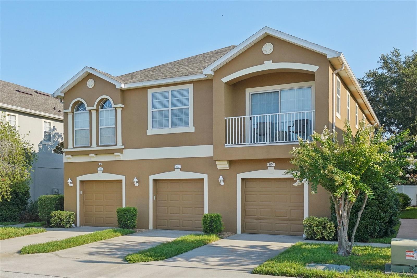Welcome to this move-in–ready end-unit gem in the gated Eagle Palm pool community, where luxury, convenience, and smart living converge. Impeccably maintained, this two-story townhome boasts three bedrooms, two-and-a-half baths, and a one-car garage pre-wired with 220 V/70 A for seamless EV charging and No CDD; one of the only homes to feature $40,000 of hurricane impact vinyl windows including sliding glass doors—offering energy efficiency, noise reduction, security, and a transferable warranty. Inside, sunlight floods the 16'×13' open-concept living and dining area—complete with durable laminate wood floors, elegant 5" crown molding, and a built-in 5.1 Dolby Digital surround-sound system—while Wi-Fi-enabled LED lighting brightens every corner. A high-end $4,000 hard-wired 24-hour DVR camera system with full audio recording, a 180° front-facing camera, and interior camera covering the first floor integrates to your mobile device at no monthly charge and pairs with a front-door video doorbell for fully integrated alerts and total peace of mind. Recent upgrades include new water shut-off valves throughout, in 2025 community roof was replaced, a new water heater, and Corian countertops where repolished. The gourmet kitchen dazzles with 42" wood cabinetry topped with crown molding, an extended breakfast bar, Samsung and GE appliances, recessed lighting, brushed-nickel hardware, and a cozy dinette. Upstairs, retreat to the spa-inspired primary suite with dual sinks, a soaking tub, and a generous walk-in closet, while two additional bedrooms share a beautifully appointed bath. Outside, entertain on your private patio or unwind at the community pool and clubhouse. Minutes from MacDill AFB, the Selmon Expressway, I-75, Brandon Mall, premier shopping centers, and the Xtreme Movie Theatre, this turnkey Eagle Palm treasure is ready to welcome you home—schedule your private tour today!