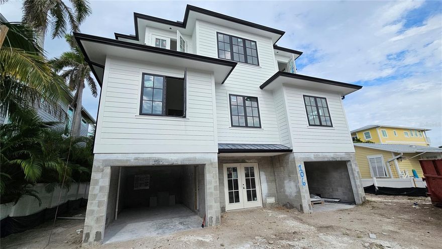 Under Construction. Welcome to your dream coastal oasis! This brand-new, turnkey furnished construction home in Bradenton Beach offers a perfect blend of luxury, comfort, and breathtaking views. With 8 bedrooms, den, 7 1/2 bathrooms and 3,421 square feet of meticulously designed living space, this residence is the epitome of Florida living at its finest. As you step inside, you'll be captivated by the stunning bay views that greet you from multiple vantage points. This residence is a true tropical paradise, surrounded by swaying palm trees and featuring a private pool and hot tub. Enjoy endless outdoor living and entertaining possibilities with an abundance of patio space. For those who crave the ultimate coastal experience, a rooftop deck awaits, where you can savor both sunrise and sunset views over the serene bay waters. Great room floor plan is perfect for entertaining Large dining room is next to the chef's kitchen equipped with high-end appliances, a spacious center island with a breakfast bar, and a generous pantry which makes this home perfect for gatherings and relaxation. Designer lighting throughout and accent walls add an elegant touch to the interior, enhancing the overall ambiance. Just steps away, you'll find easy access to the bay and the beautiful sandy beaches, making this location truly ideal. Explore the vibrant Bridge Street with its charming shops and restaurants, and take advantage of the nearby marina for all your boating needs. This property offers an exceptional investment opportunity, with projected rental income available upon request. Whether you choose to make this your permanent residence or an income-generating vacation home, every day will feel like a vacation as you immerse yourself in the coastal lifestyle. Don't miss the chance to own this exquisite piece of paradise in Bradenton Beach.