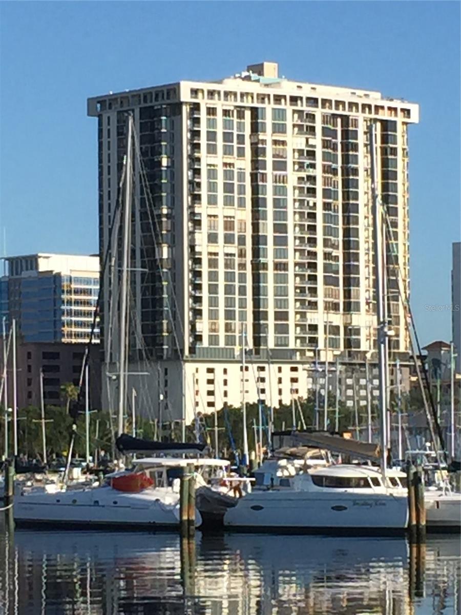 Bayfront Tower. Perched high above the heart of Downtown St. Petersburg, this beautifully updated 2 bedroom 2 bathroom residence combines modern elegance with timeless comfort. The open floorplan welcomes you with abundant natural light streaming through triple-pane, high-efficiency impact-rated windows, while tile floors throughout create a seamless flow from room to room. The kitchen, updated in 2017, is designed for both style and functionality with Bosch stainless steel appliances, quartz countertops, and ample cabinetry. The expansive living space extends effortlessly to an exceptional balcony that faces East with room for a table and 4 chairs or two large recliners, perfect for entertaining or simply enjoying panoramic park water views of Tampa Bay. A flexible office/den/media room provides versatility to suit your lifestyle, while both the primary and second bedrooms offer generous walk-in closets for exceptional storage. Every detail has been thoughtfully chosen to balance sophistication and comfort, from the durable finishes to the airy, open layout. Residents of this sought-after community enjoy world-class amenities including 24-hour security and concierge service, valet parking, a rooftop pool with breathtaking views, a state-of-the-art fitness center, exercise and massage rooms, a game room, library, and more. With four main elevators ensuring minimal wait times, every detail of convenience and luxury has been considered. Perfectly situated in the heart of vibrant St. Petersburg, this home offers unmatched access to fine dining, waterfront parks, cultural attractions, and the lively downtown lifestyle.