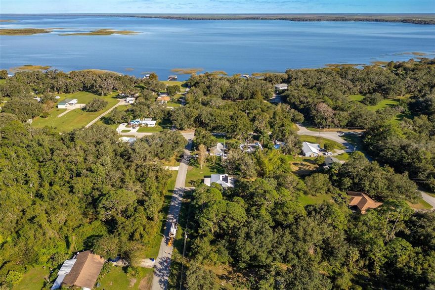 Welcome to this charming and meticulously maintained 3-bedroom, 2-bathroom gem, located just a block from the sparkling waters of Lake Istokpoga in the peaceful town of Lake Placid. This home sits on a high-elevation lot (Flood Zone X) with no HOA or CDD fees, providing stress-free living in a tranquil, one-of-a-kind community. The property boasts a sturdy metal roof complemented by energy-efficient solar panels and has no history of storm damage. The private, fenced backyard is beautifully landscaped, providing a serene oasis perfect for pets, outdoor relaxation, or gardening. Inside, you’ll find a warm and inviting space featuring updated bathrooms, an efficient kitchen with modern finishes, and gorgeous flooring throughout. The home also includes thoughtful touches like a Nest thermostat, a generator plug to power the entire house, a carport, and a storage shed for added convenience. Enjoy your mornings on the screened porch or lanai while soaking in the quiet beauty of nature. With proximity to parks and wildlife, this property is ideal for nature enthusiasts, animal lovers, snowbirds, first-time homebuyers, or savvy investors. Don’t miss out on this rare opportunity to live near the water without the risks, in a cozy and charming Florida retreat.