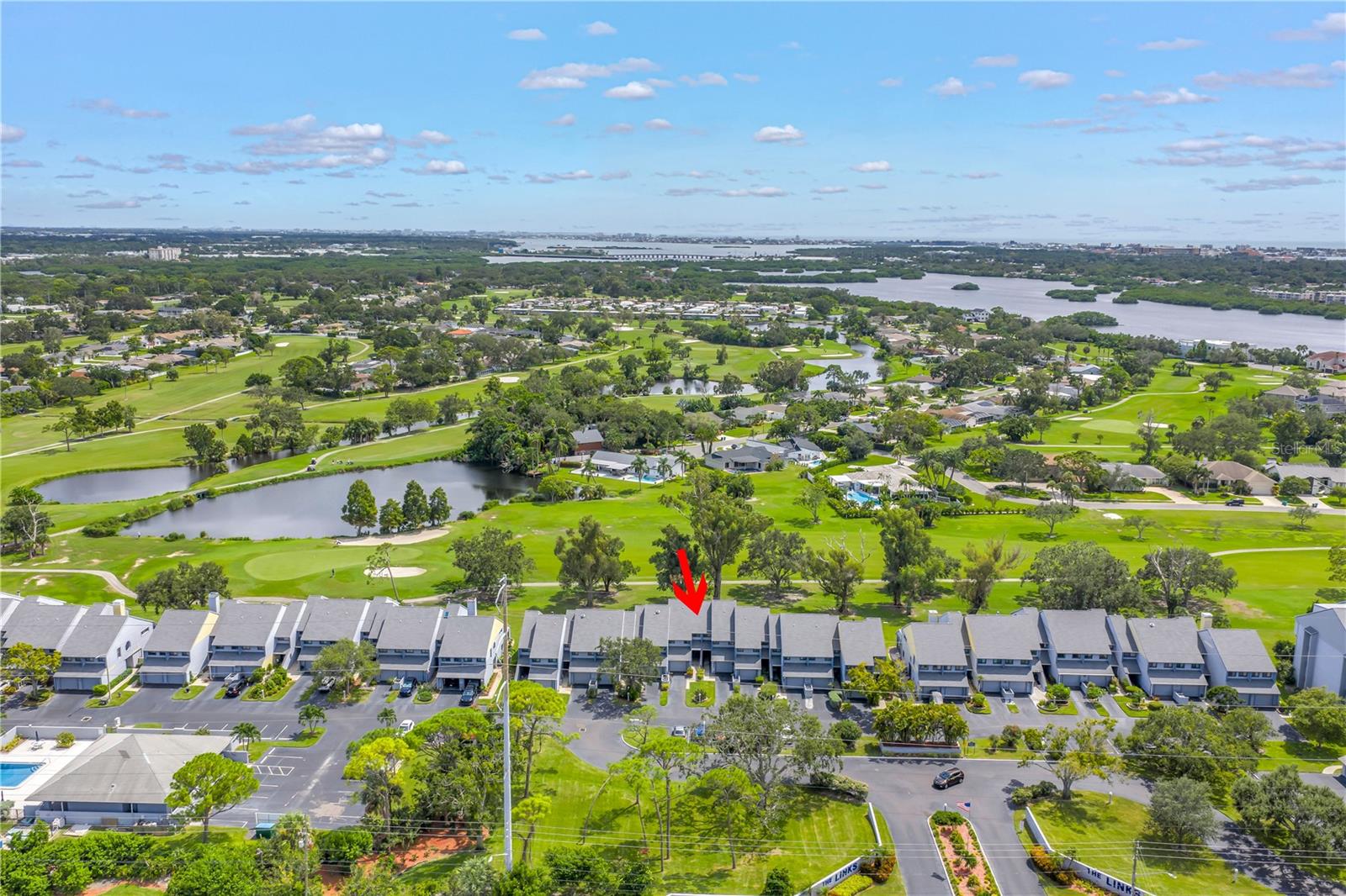 Welcome to this highly desirable townhome in The Links, perfectly situated on the 5th fairway of Seminole Lake Golf and Country Club. Featuring an open floor plan, beautiful wood flooring, and sliding glass doors that lead to the lanai, this home is bathed in natural light and offers serene golf course views. The oversized master suite is a true retreat, complete with a private balcony overlooking the fairway, a spacious walk-in closet, and a luxurious master bath. The second bedroom also features wood flooring, a walk-in closet, and a private bath, making it ideal for guests or family. Step outside to enjoy the community pool and spa, perfect for relaxing or entertaining. With the condo maintenance fee covering the roof, building exterior, water, sewer, trash, grounds, pool maintenance, and flood insurance on the building and recreation facilities, day-to-day living is effortless. New water softener, new water heater, newer AC and new roof by the association. Conveniently located just minutes from Seminole City Center, beautiful beaches, city parks, and easy highway access, this townhome offers both lifestyle and convenience. Additional features include generous storage space and an oversized garage. Don’t miss the opportunity to own this exceptional home—schedule your private showing today!