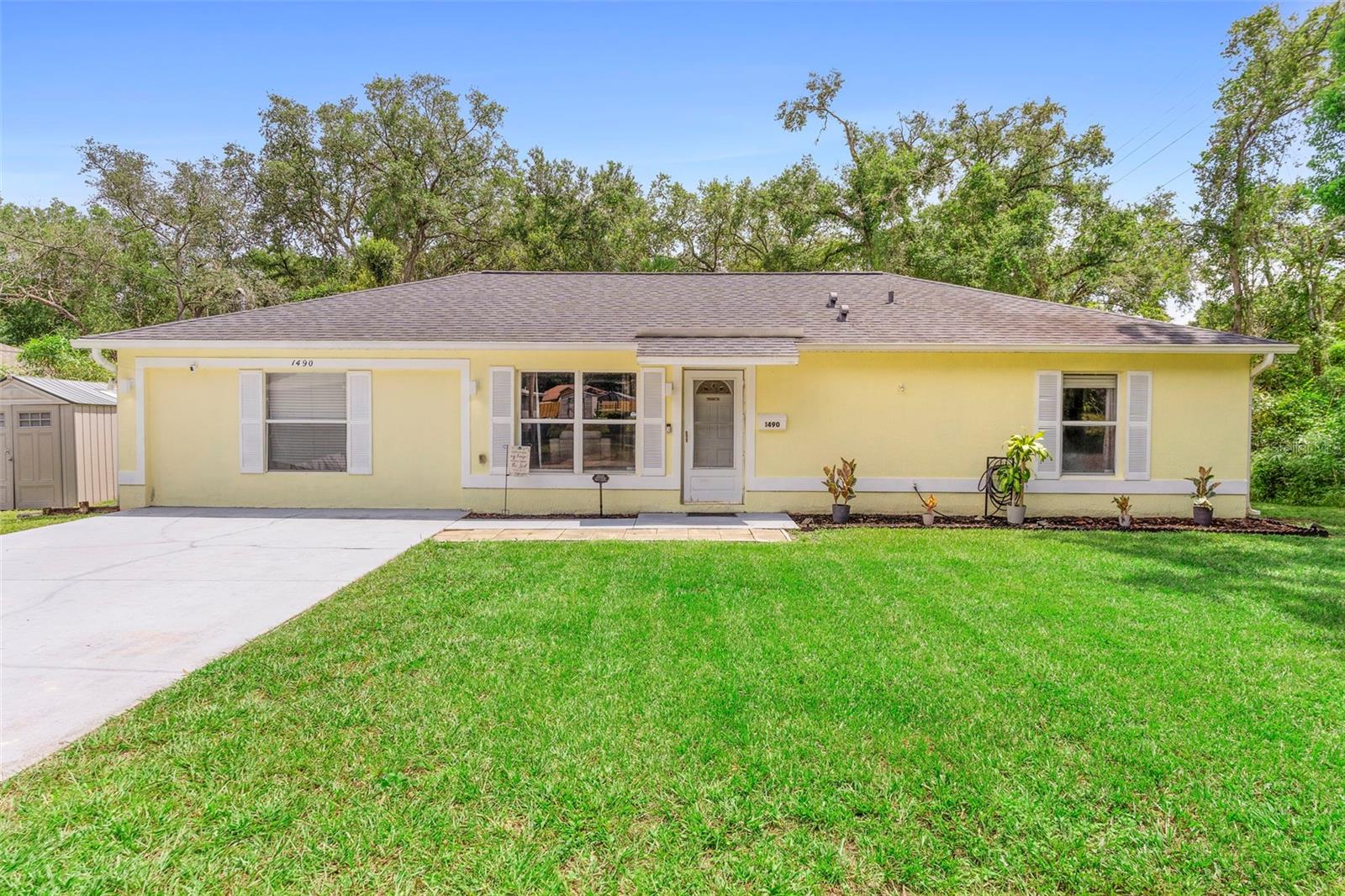 Beat the summer heat in your own private pool oasis! This meticulously maintained 4-bedroom, 2-bath contemporary home is situated on a spacious 100x100 corner lot in unincorporated Volusia County. Built in 2004 and offering 1,568 square feet of living space, this home features an in-ground vinyl pool with a new liner, heater, salt system, new pool pump, and a large pool deck all enclosed by a vinyl privacy fence for added seclusion.
The open-concept layout includes volume ceilings, plant shelves, and no carpet throughout. The stylish kitchen offers a breakfast bar and connects seamlessly to the main living areas, making entertaining a breeze. The interior has been freshly painted and includes updated light fixtures, creating a bright and modern feel.
The garage has been converted into a fourth bedroom, which could also serve as a family room, office, or bonus space. If desired, there is ample room on the lot to build a garage. The covered patio includes a retractable screen, perfect for relaxing outdoors.
Additional features include a water softener, inside utility room, new well pump, leaf filters on the gutters, and a roof and HVAC that is only five years old. Both bathrooms have been updated and the private backyard provides a peaceful retreat.
Located just 20 minutes from the beaches and 30 minutes from Orlando and Blue Springs State Park, this home combines comfort, convenience, and pride of ownership.