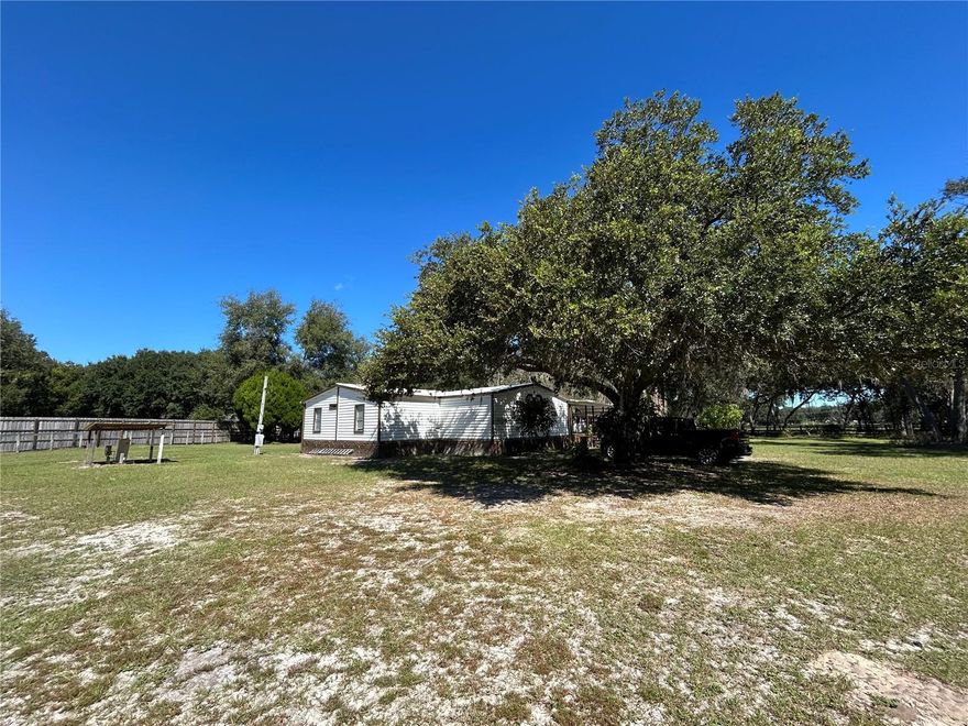 5-bedroom, 3-bath manufactured home on 5.02 acres in Polk City. This 1,836 sq ft home offers an open floor plan, a large kitchen, and plenty of natural light. The property includes mature trees and open land. Located on SR 33 with easy access to main highways. Includes a 13 ft x 27 ft front patio, an adjacent awning for vehicles, and a shed. There is also an unused well in the north east section of the property.