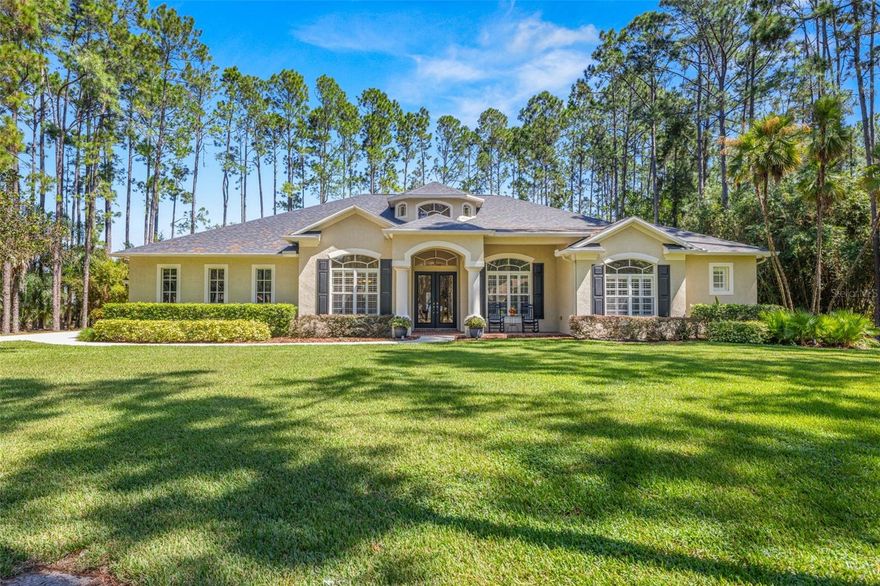This one-of-a-kind custom estate, set on a wooded one-acre lot within a secure gated Lutz community, combines timeless architectural detail with modern comforts and exceptional care by its original owners. Just 30 minutes from Tampa International Airport, the home welcomes you with a grand rotunda featuring soaring 20-foot ceilings, while the Great Room, Dining Room, and Study/Office boast 12-foot ceilings and the remaining spaces gives 10-foot ceilings for a bright, open feel. Interior highlights include custom stonework in the Rotunda and Great Room accented by architectural beams.  Flexible rooms for studies or creative use, and a separate wing with double French doors—perfect as a child’ retreat, guest suite, or in-law quarters. The thoughtfully designed layout also provides a designated space for a second refrigerator adjacent to the kitchen, along with a built-in security system. Outdoor living shines with an oversized enclosed athletic pool, a cozy firepit, and exterior accent lighting, while an invisible fence ensures pets can roam freely. Recent upgrades include a new roof (March 2025), a new HVAC system (April 2020), and a new water softening system (September 2025). Blending everyday comfort with elegant entertaining, this estate gives unmatched privacy and sophistication in a prime Lutz location close to shopping, dining, and Tampa conveniences.