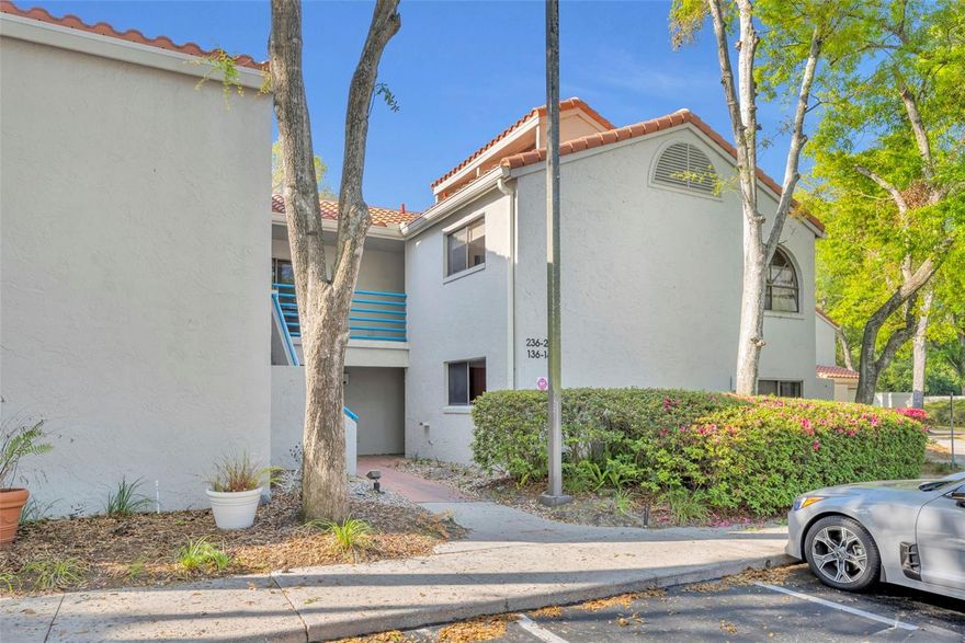 Elegantly renovated two-bedroom, two-bath second-floor condo in the gated community of Sun Bay Club on Lake Destiny in Maitland. Vaulted ceilings and abundant windows create a bright, airy atmosphere throughout. The gourmet kitchen has been fully updated with 42-inch custom hardwood cabinets, Zodiaq (Cambrian) quartz countertops, a Kohler farmhouse sink, stainless steel appliances, and porcelain wood-plank floors. The kitchen opens to the dining and living areas, featuring a built-in desk, wood-burning fireplace, custom built-ins, clerestory windows, and triple sliding doors leading to a private balcony with a storage closet. The split floorplan includes the primary suite with a walk-in closet and a renovated bath with dual vanities, hardwood cabinets, designer fixtures, a glass-block shower, and natural light from a private skylight. The secondary bedroom has two wall closets and an upgraded bathroom with custom cabinets, a tub, and a skylight. Meticulously maintained with pride of ownership reflected throughout. Features include double-door entry, knockdown ceilings, designer finishes, ample storage, and an interior laundry closet. Additional updates include a new Carrier AC (2023), a new hot water heater (2025), and a new tile roof with gutters, downspouts, and skylights (2024). Sun Bay Club offers a beautiful lakefront pool, lake access with a boat ramp, a tennis court, a dog park, a community meeting room, and a car wash area for residents. Its central location is just minutes from I-4, RDV Sportsplex, Publix, shopping, and dining. Downtown Maitland, Winter Park, and Orlando are only a short drive away.